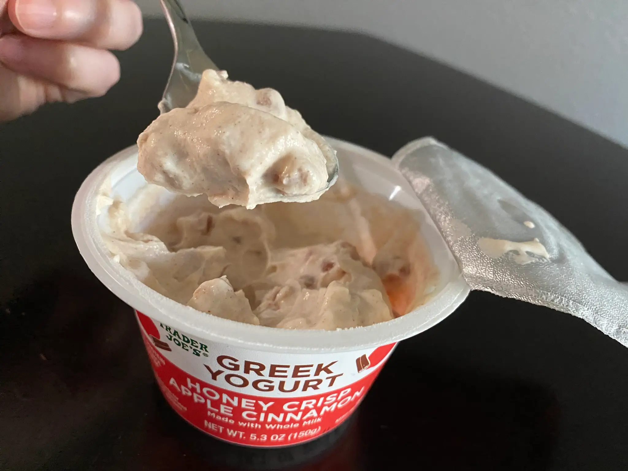 Spoon taking yogurt out of trader joe's apple cinnamon yogurt container