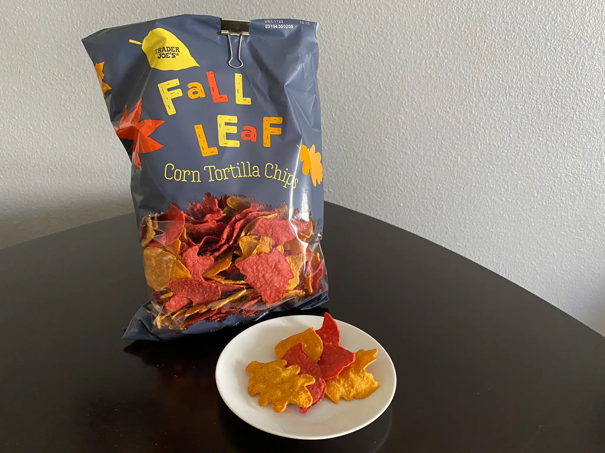 Trader Joe's fall leaf-shaped tortilla chips in bag with few on plate in front of bag