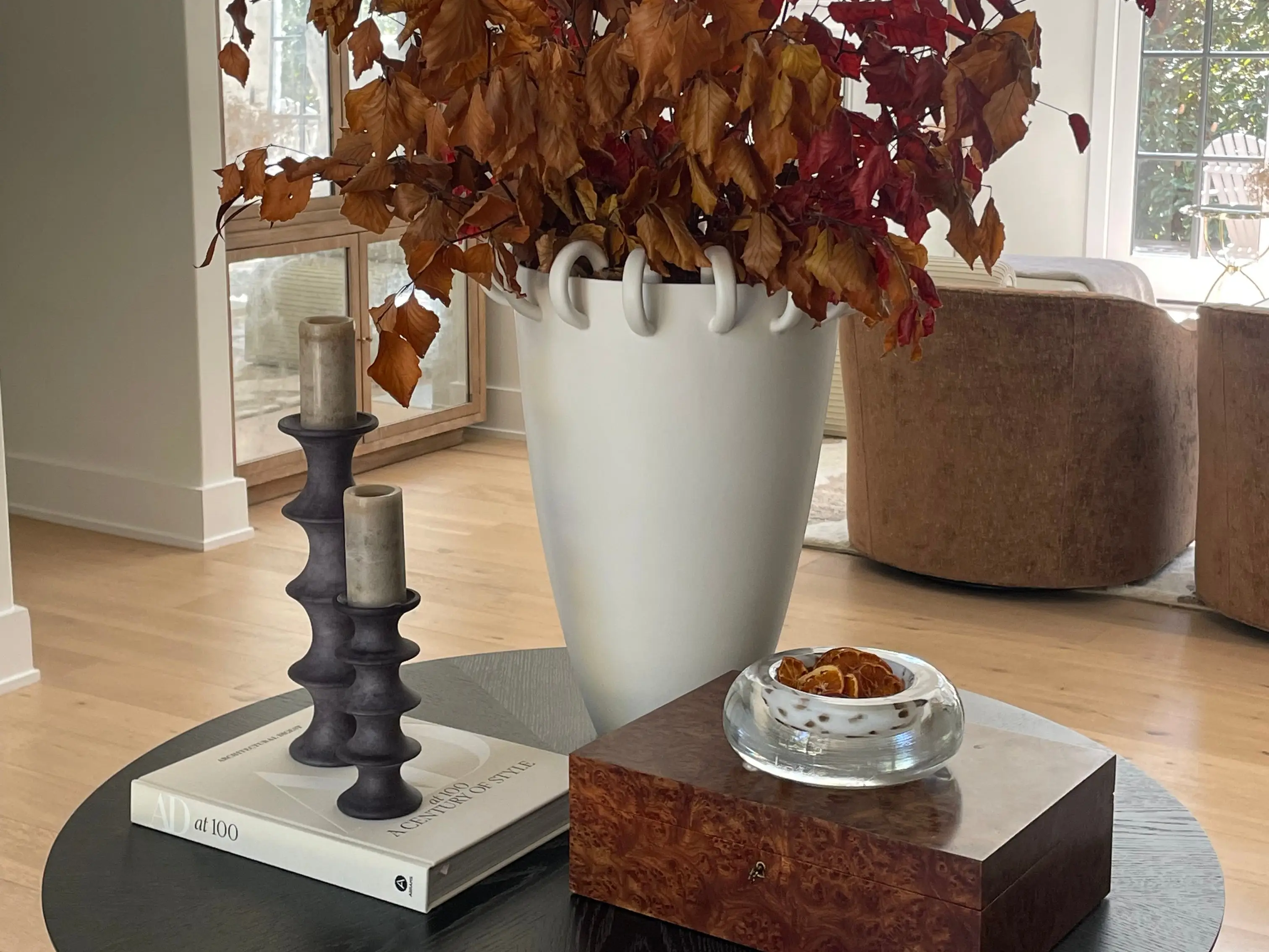 A vase with naturals on a table.