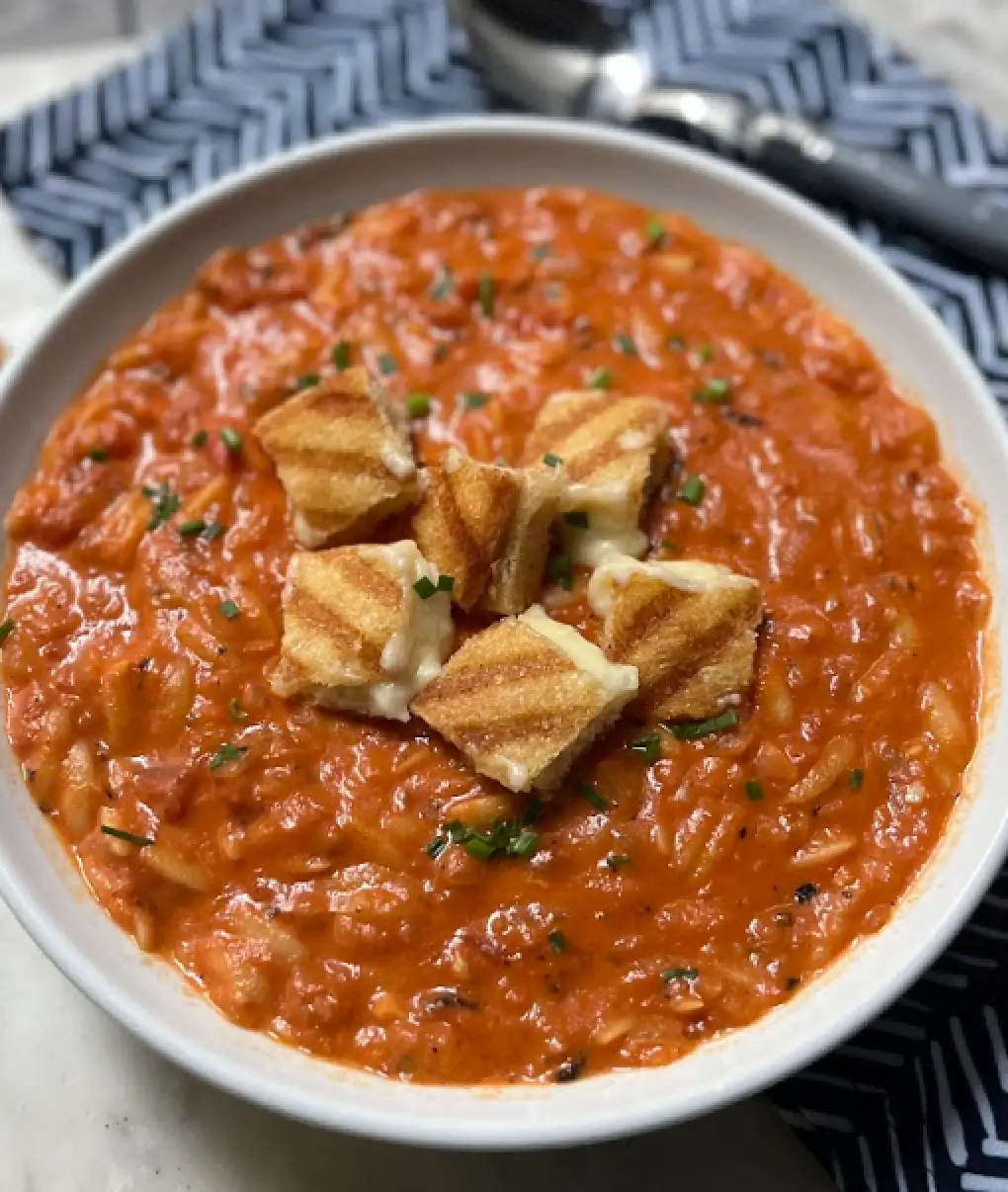 grilled cheese croutons on tomato soup in bowl