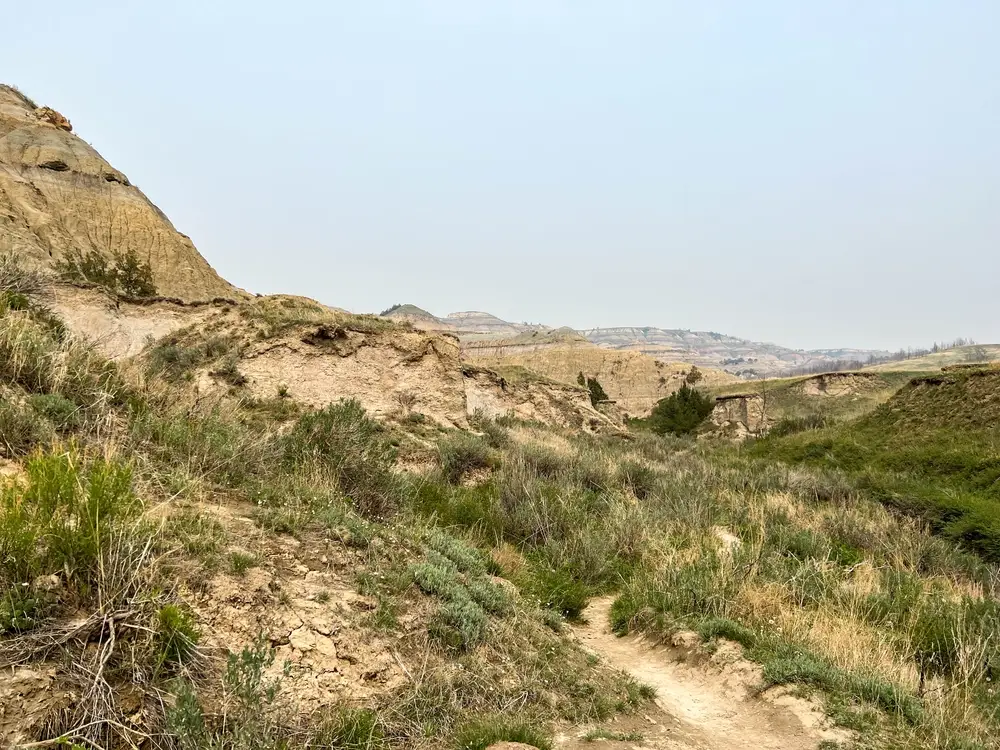 Grassy hills and rock formations in Theodore Roosevelt National Park.