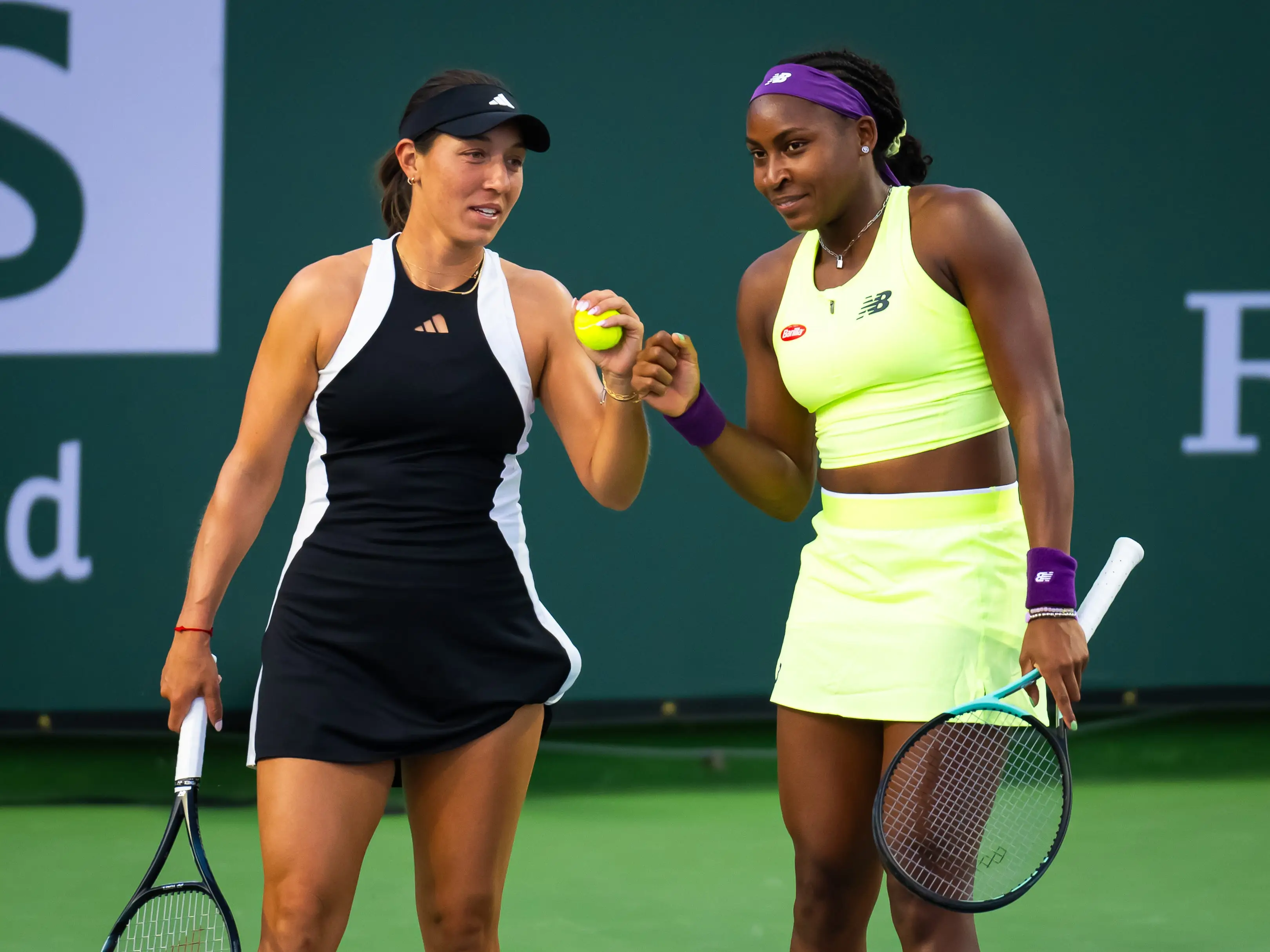 Jessica Pegula and Coco Gauff fist bump during day nine of the 2024 BNP Paribas Open.