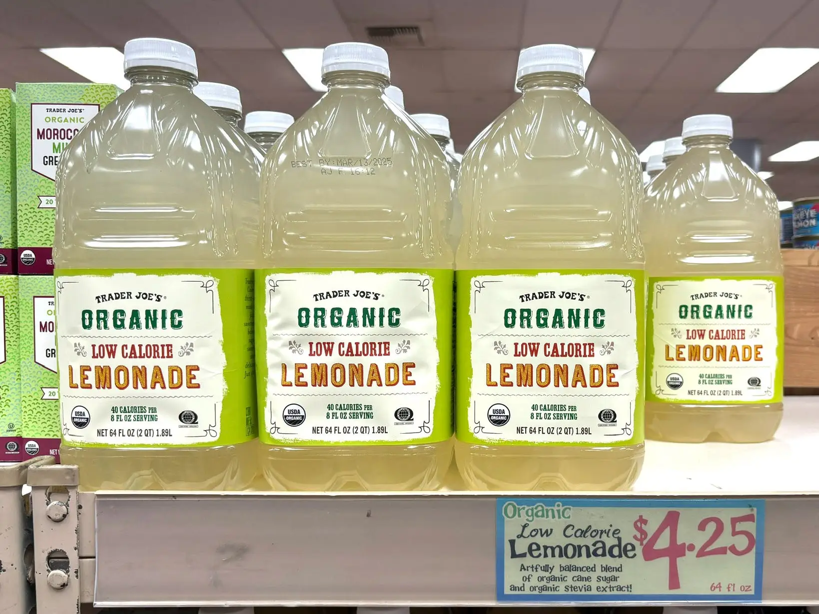 Bottles of Trader Joe's organic low-calorie lemonade on a shelf.