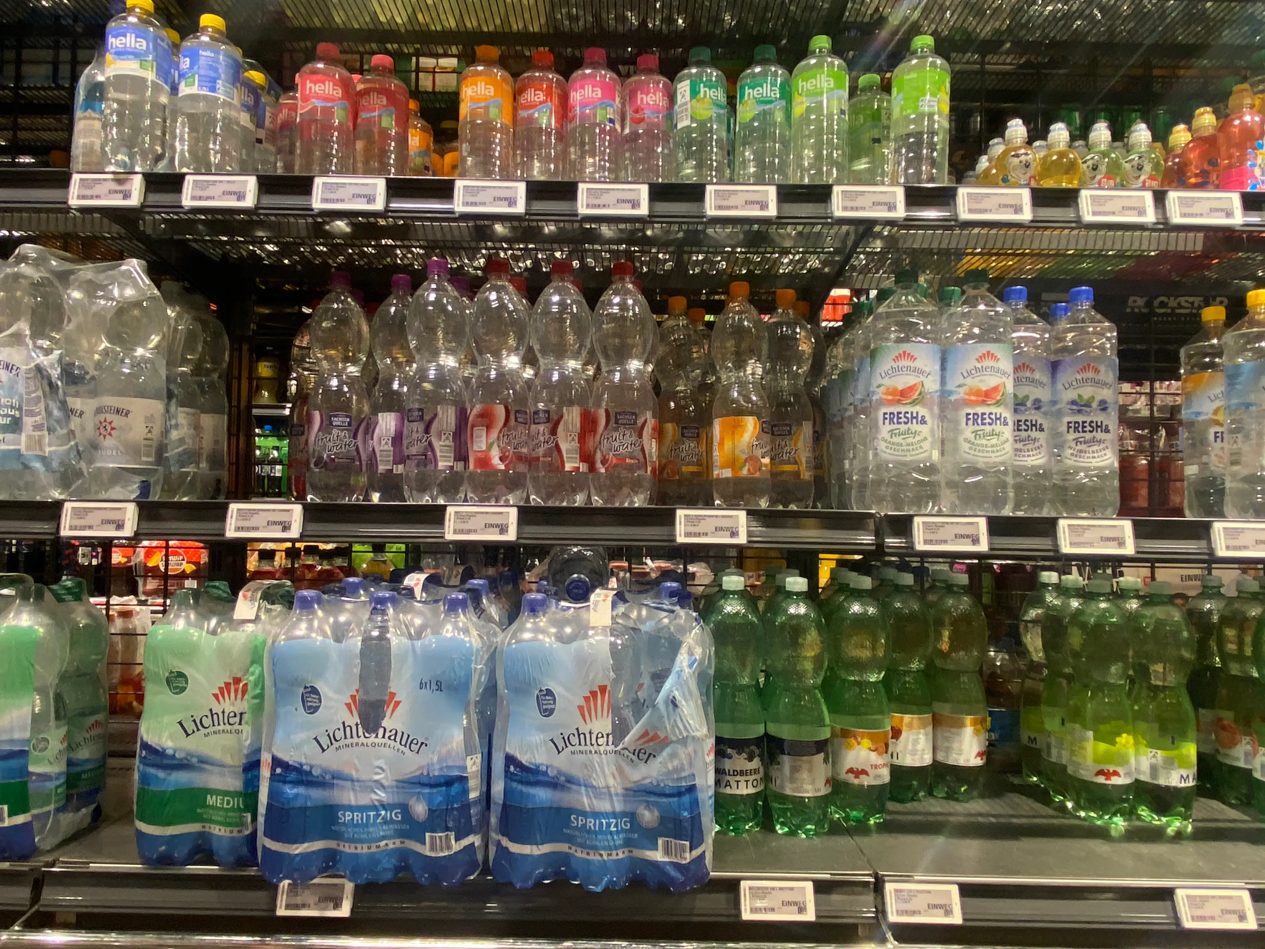 Bottles of sparkling water on shelves at a German grocery store.