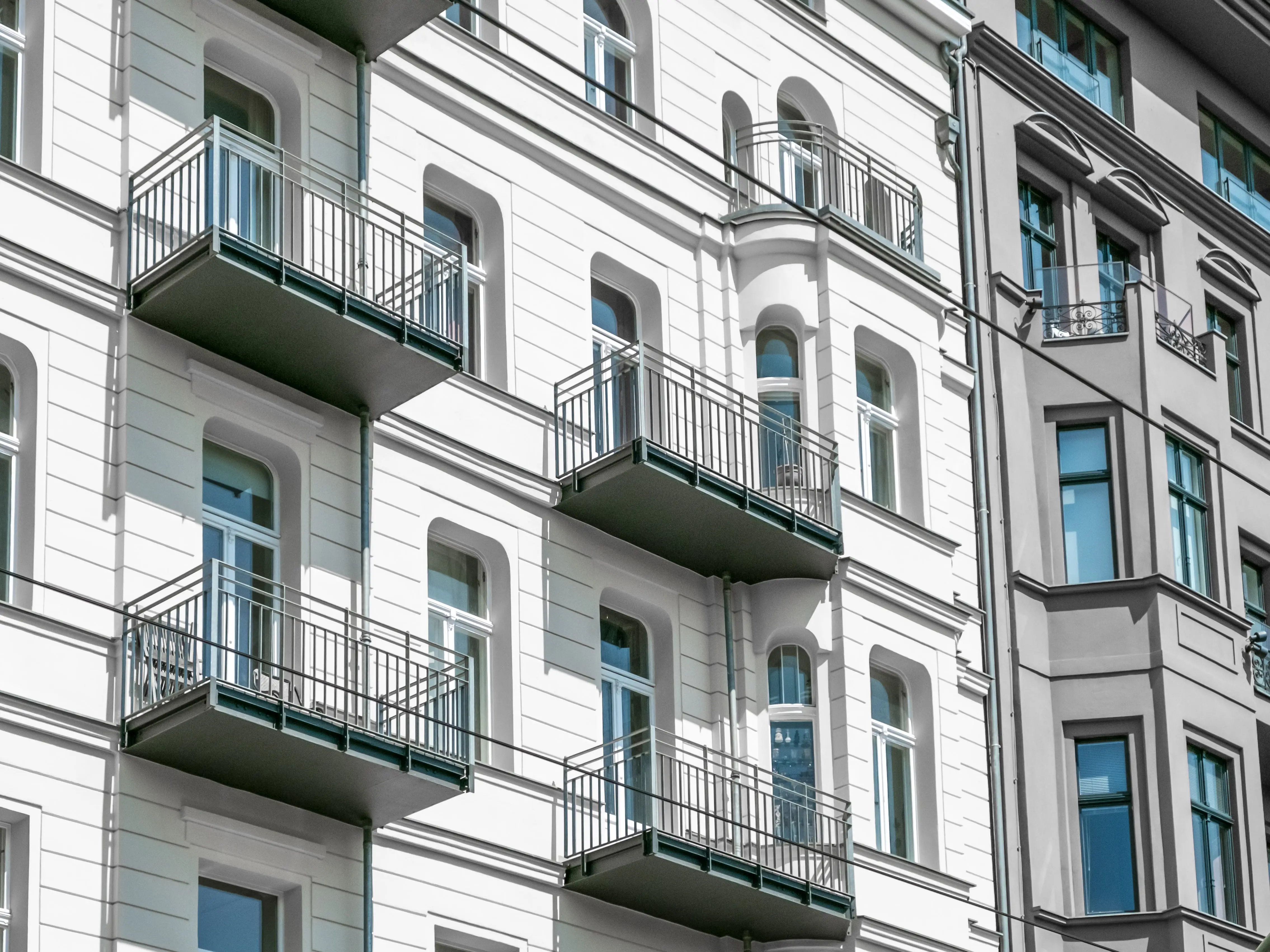 A white apartment building with balconies in Berlin.