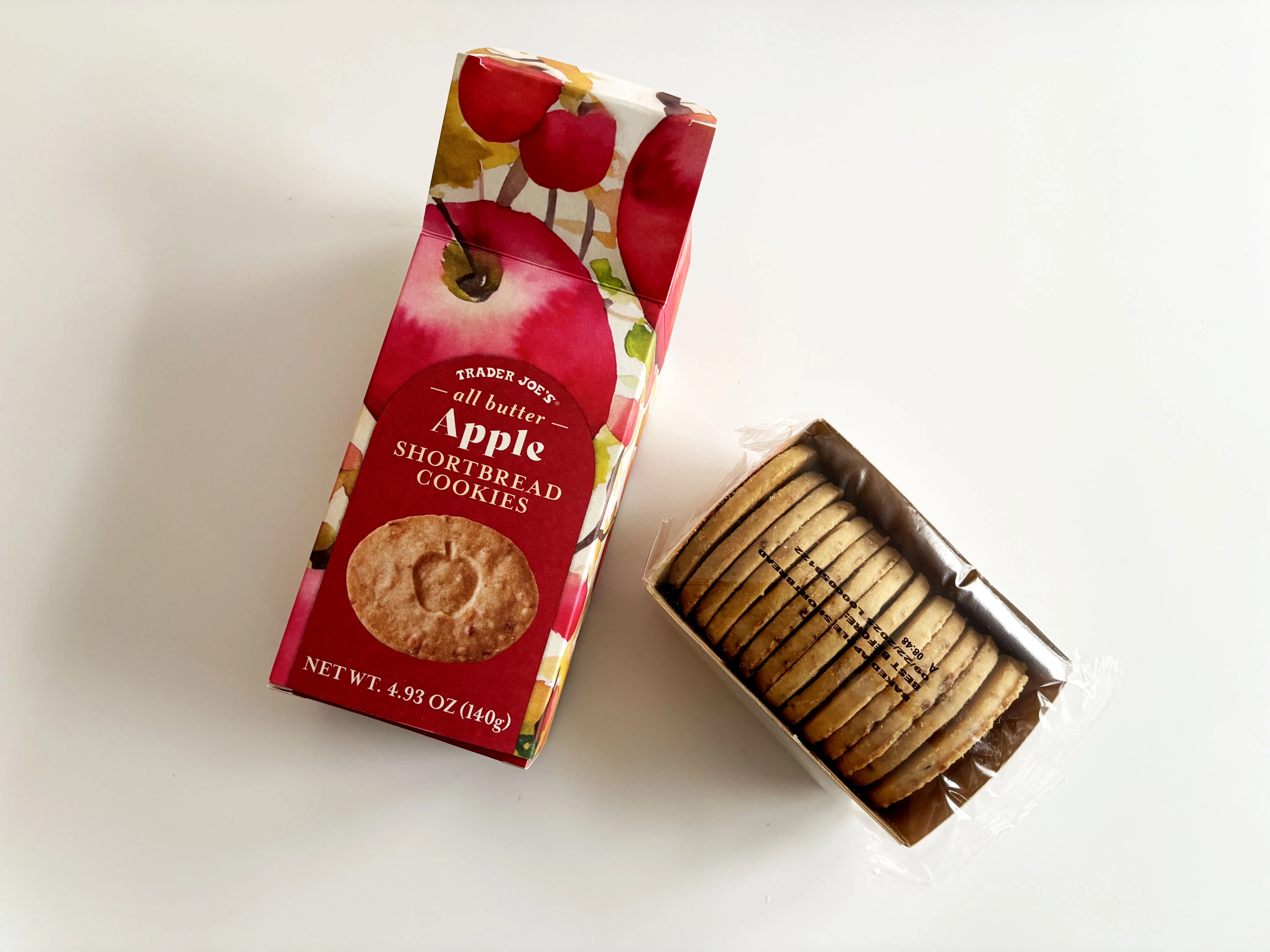 An open bag of Trader Joe’s apple shortbread cookies with a roll of the cookies wrapped in plastic.