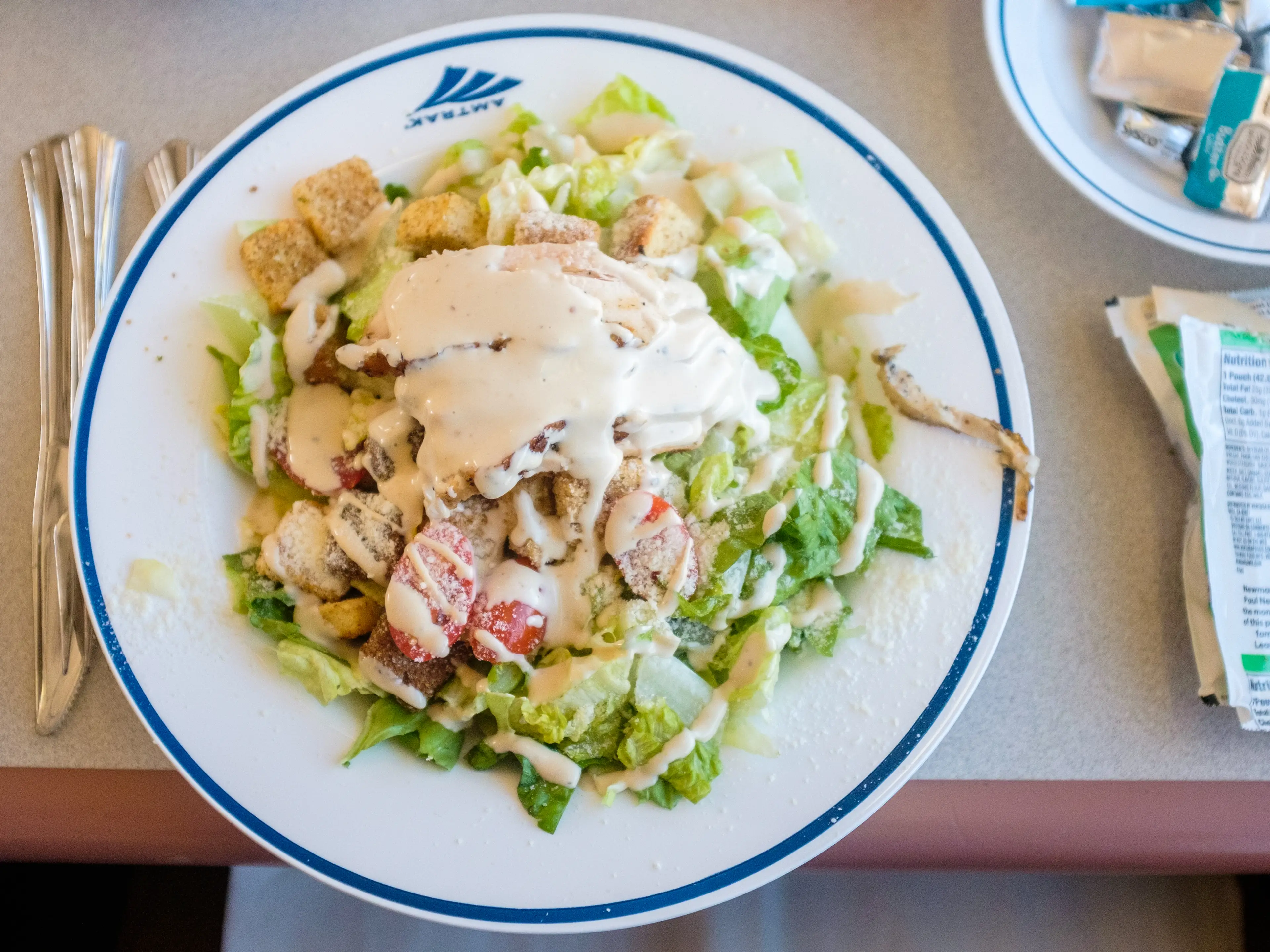 A plate with a dressed caesar salad on it