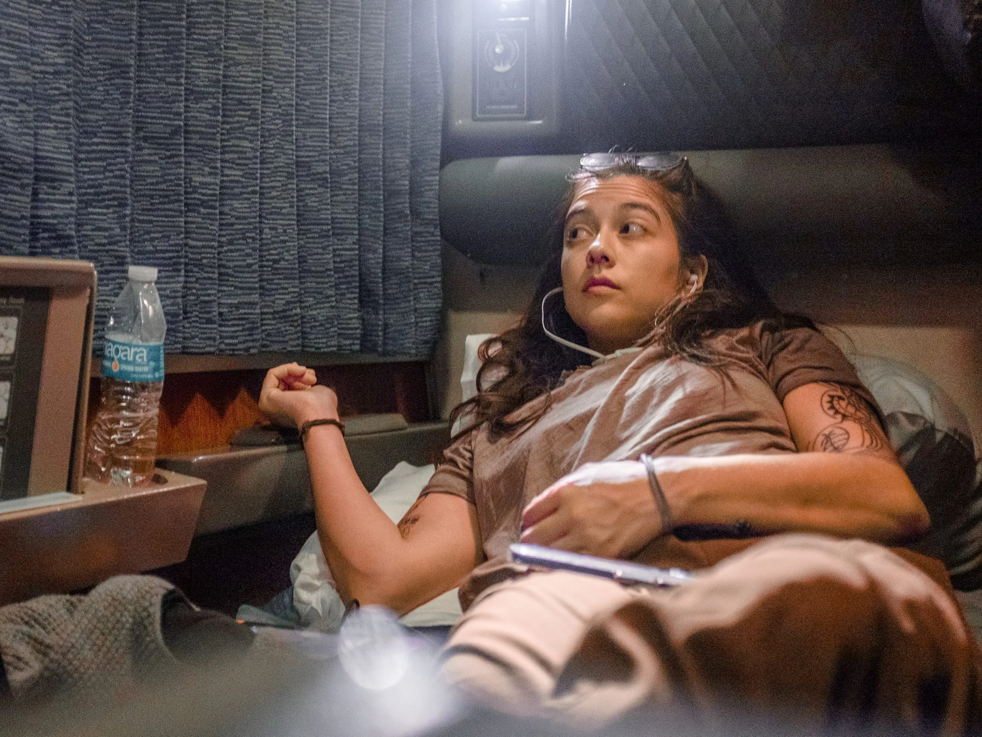 The author lays down in a train bunk with a closed window on the left