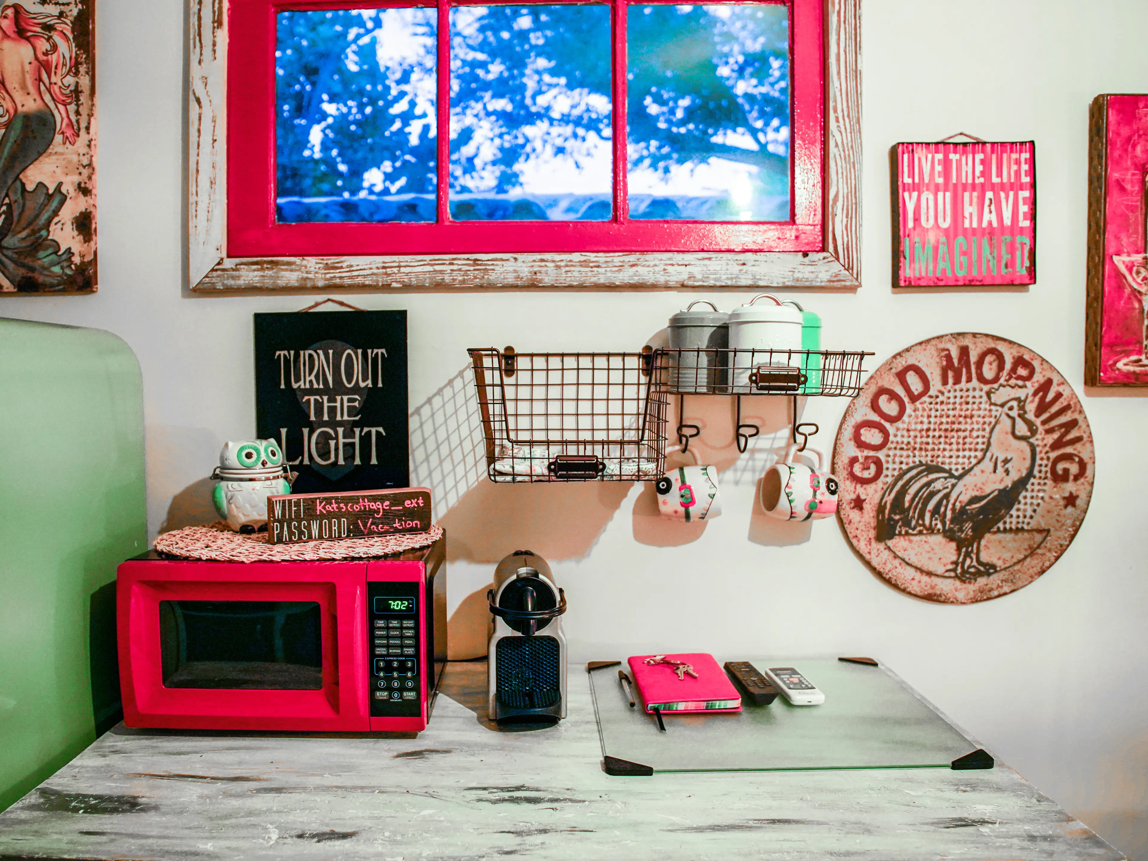 A counter in the tiny home with storage spaces and decor covering the walls