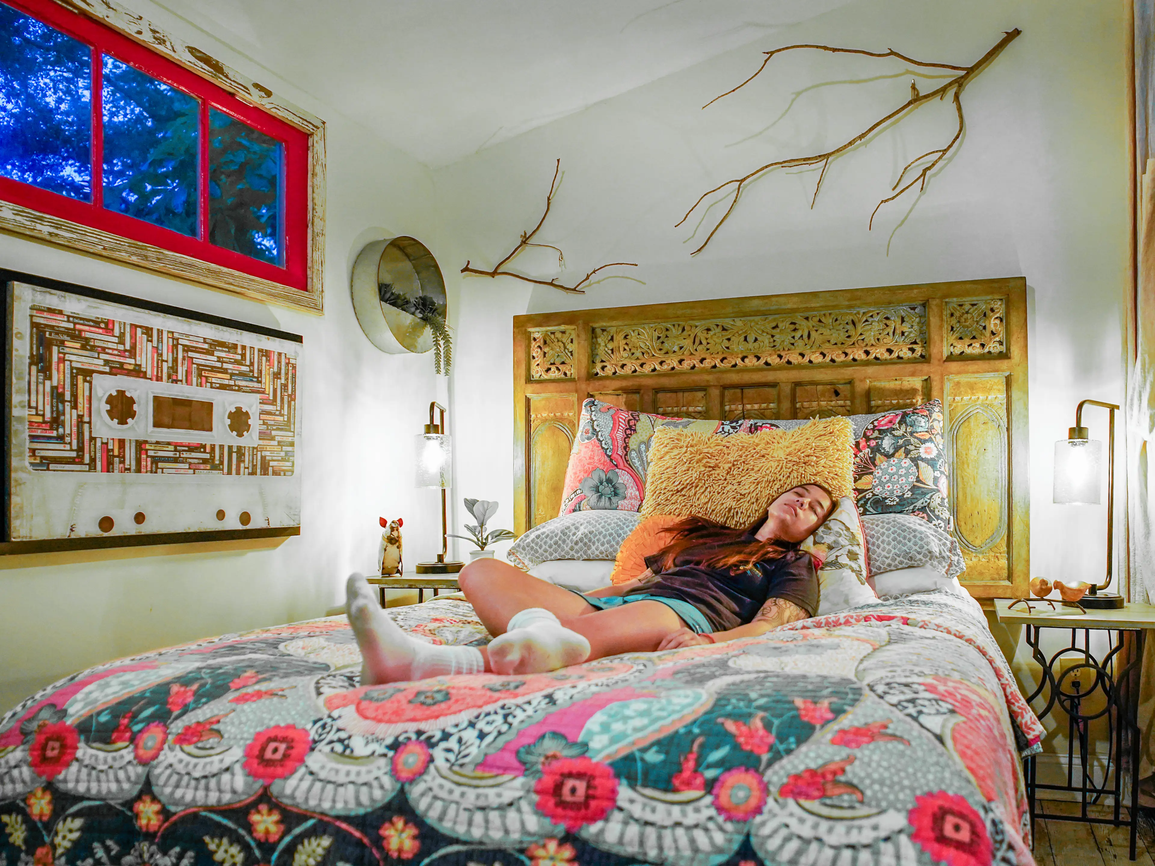 The author lays in the tiny home's bed