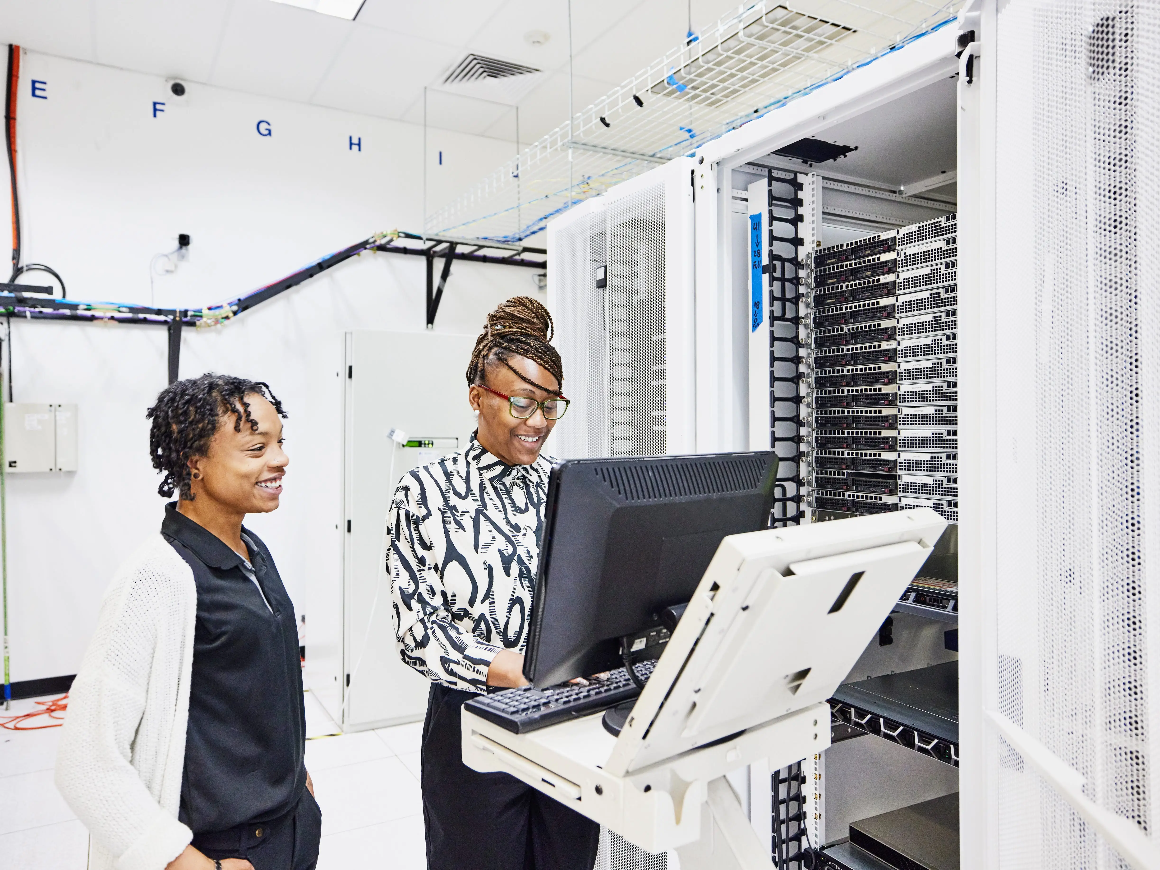 Two people looking at a computer