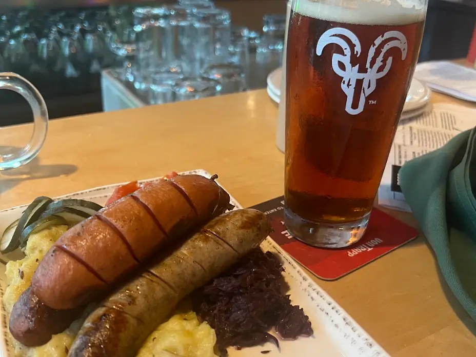 German sausages and a beer on a table.