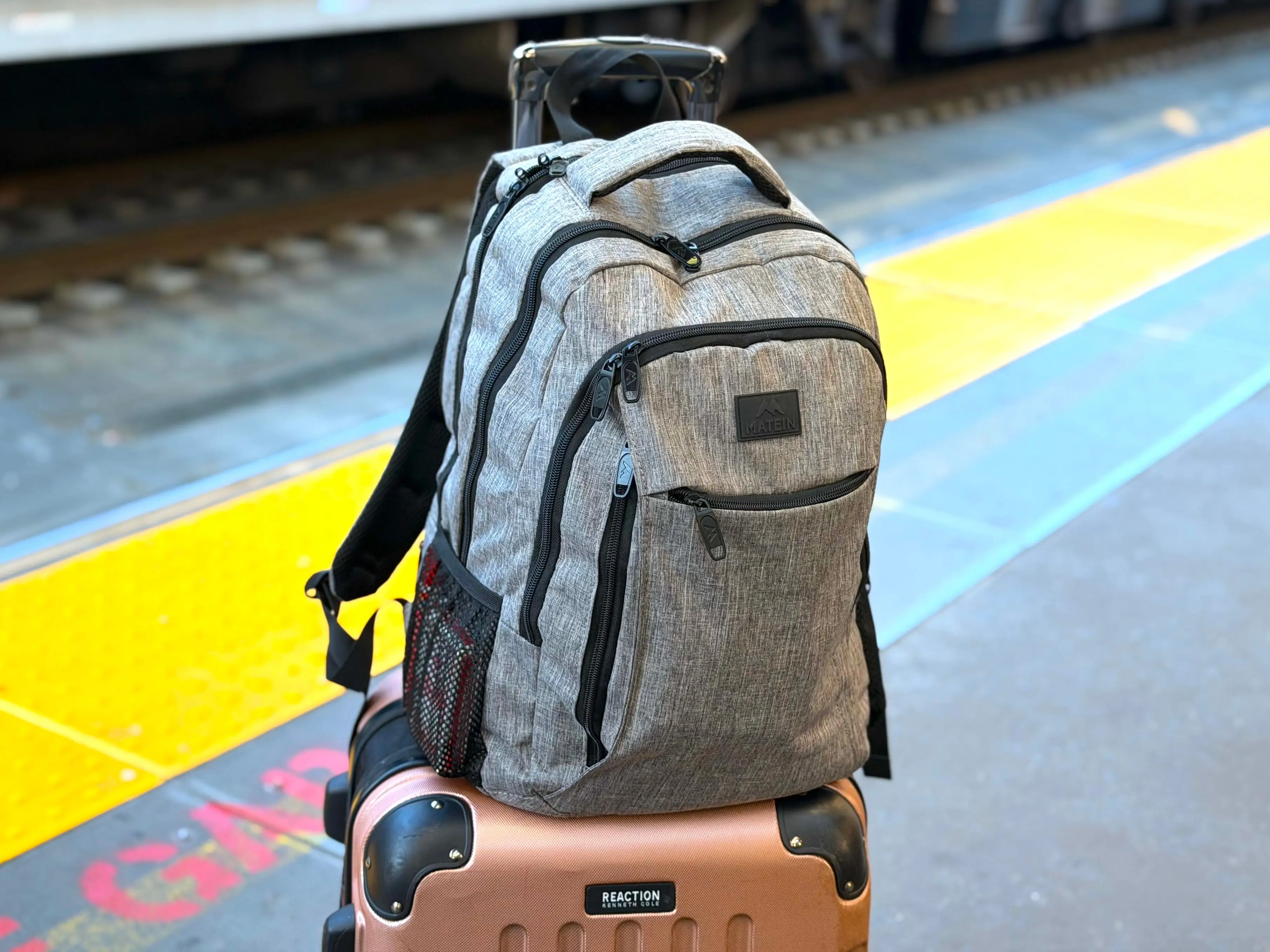 A backpack and suitcase on an Amtrak train track.
