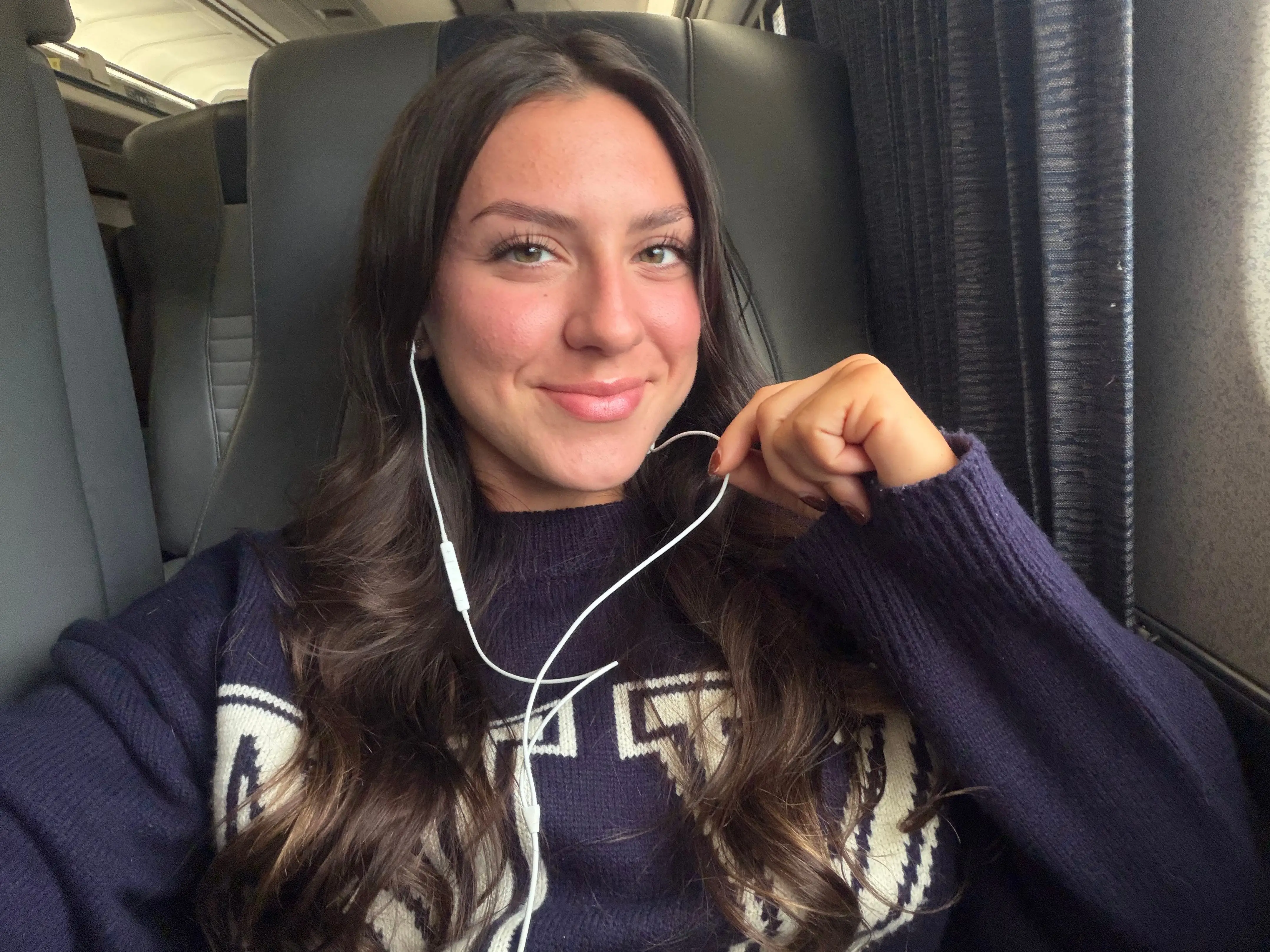 Amanda wearing wired headphones on an Amtrak ride.
