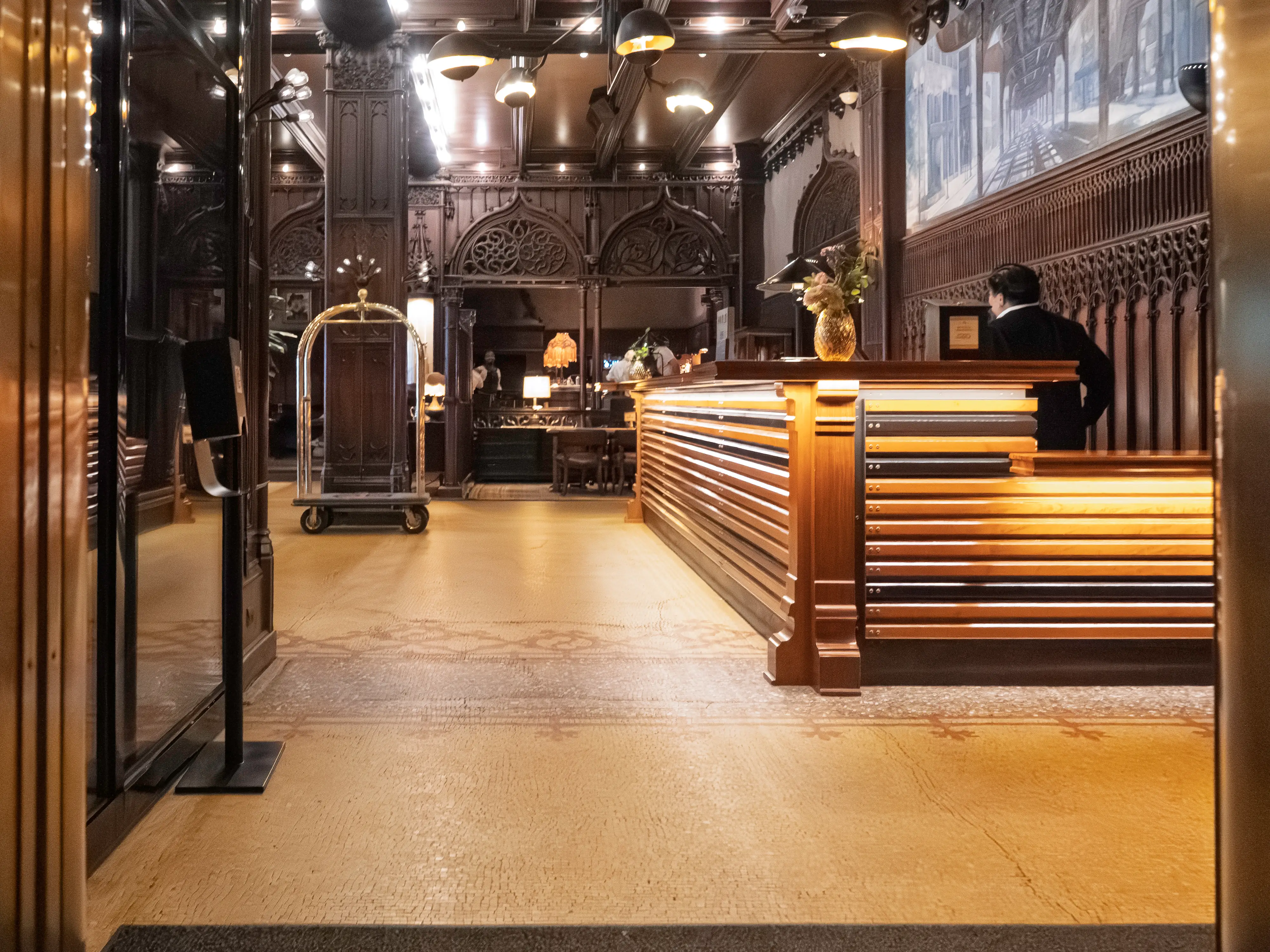 Inside the dimly lit hotel lobby with dark, wooden detailing