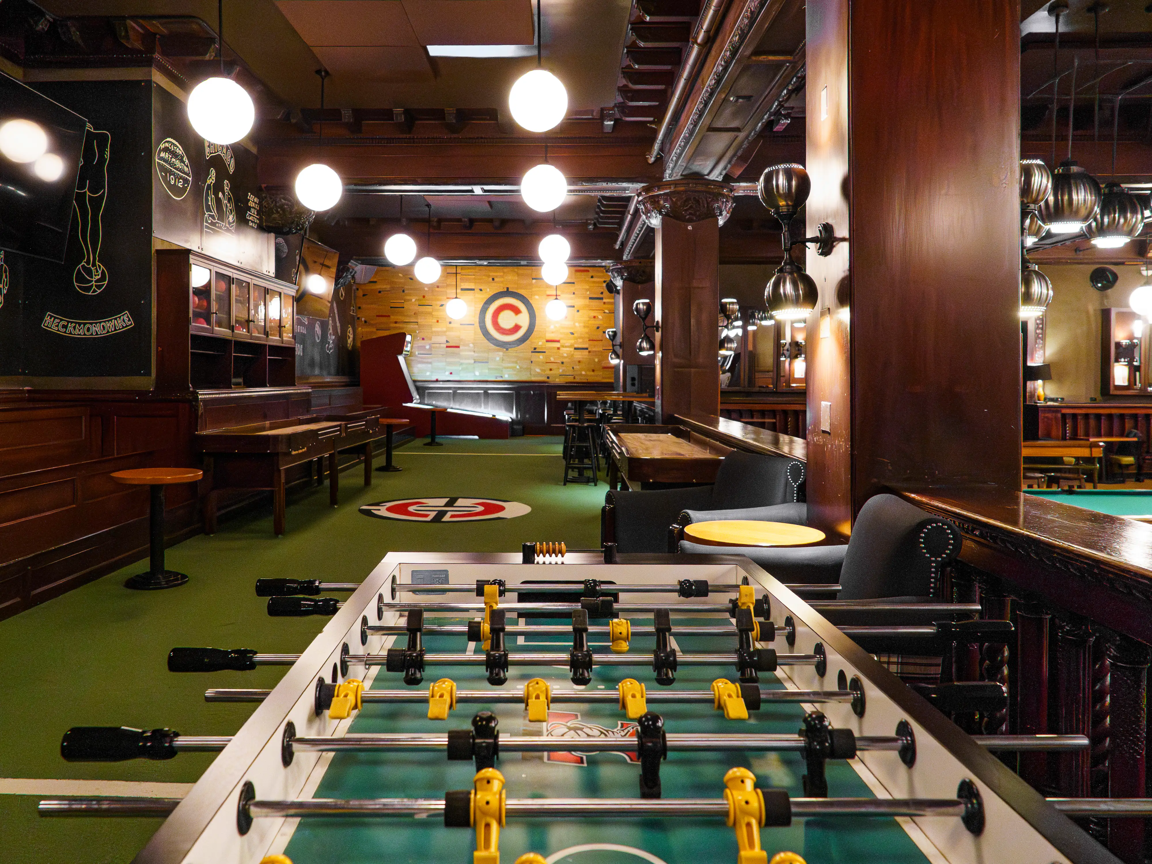 Inside an empty game room with a foosball table in the foreground