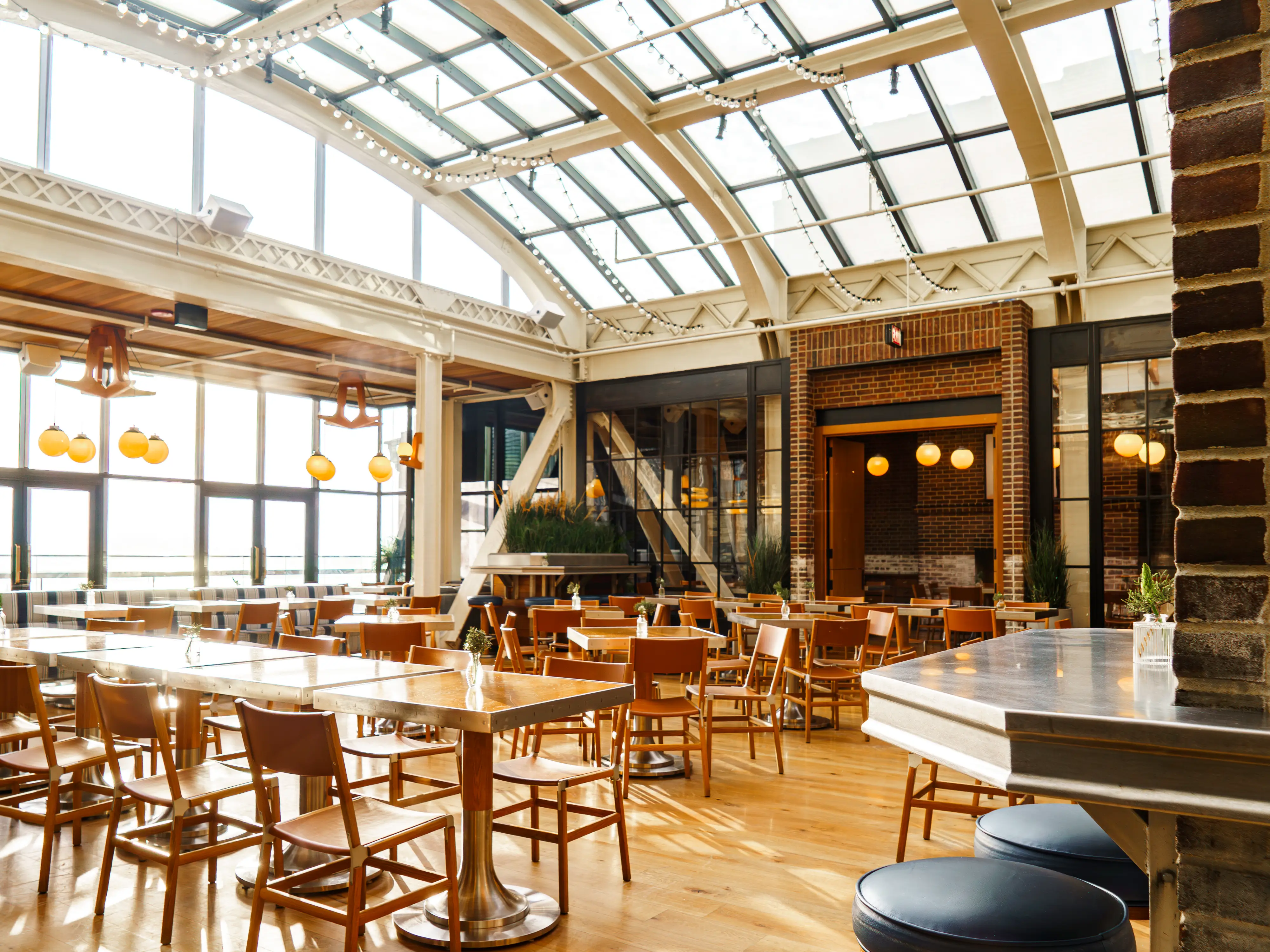 Inside an empty restaurant dining room with windowed ceilings