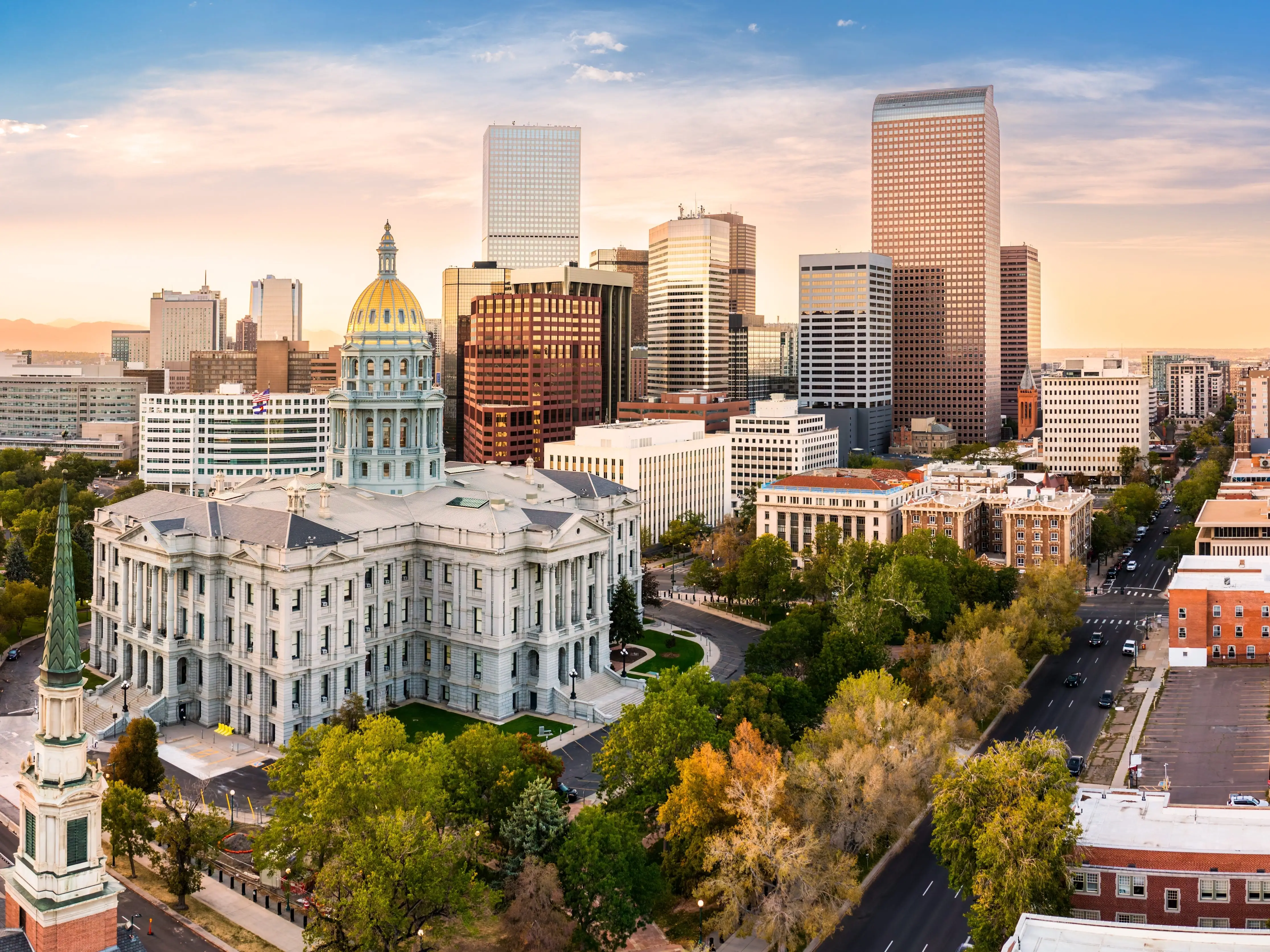 Aerial view of Colorado Capitol and Denver, Colorado skyline at sunset. Denver is a consolidated city and county, the capital, and most populous city of the U.S. state of Colorado