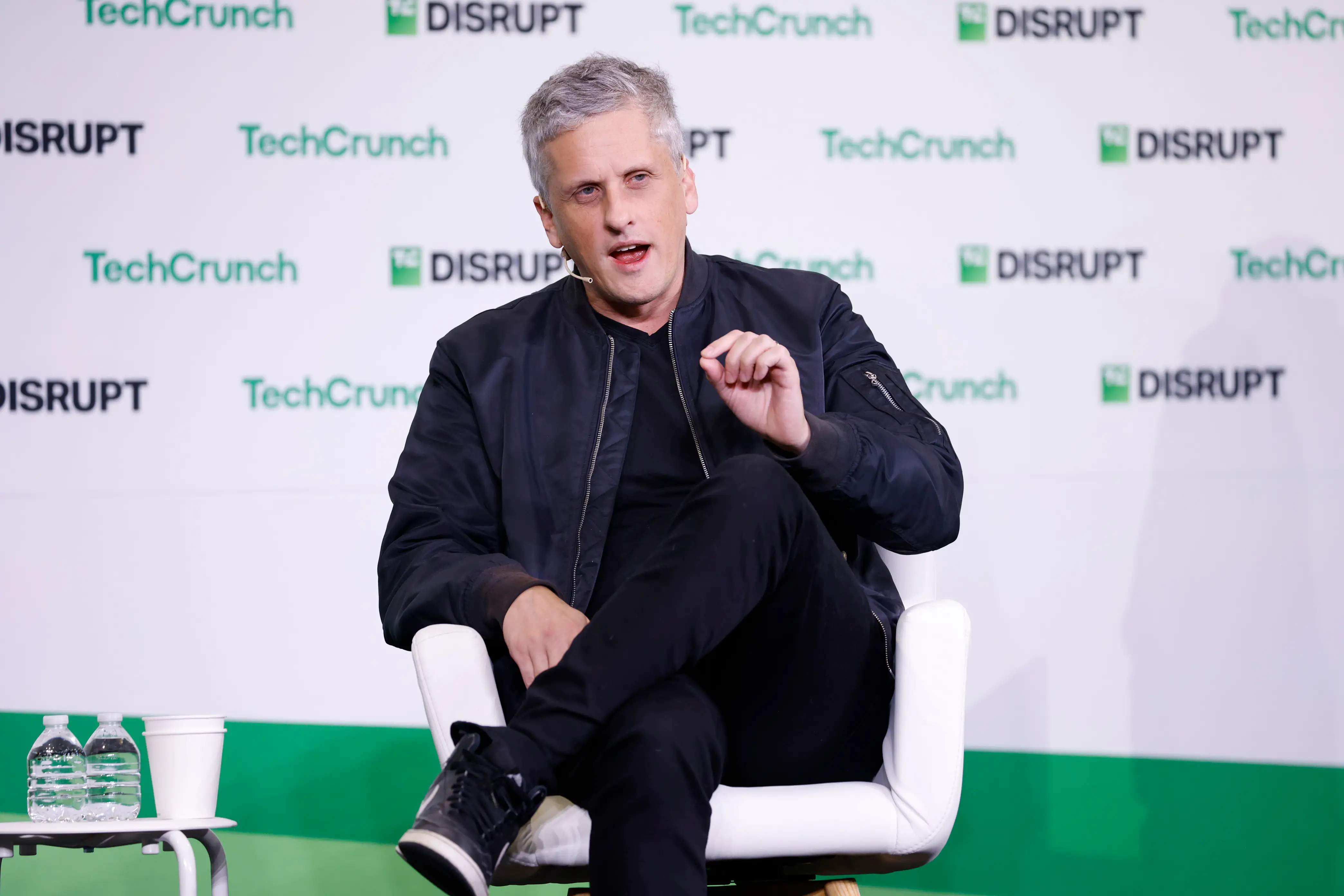 aaron levie sits on stage speaking