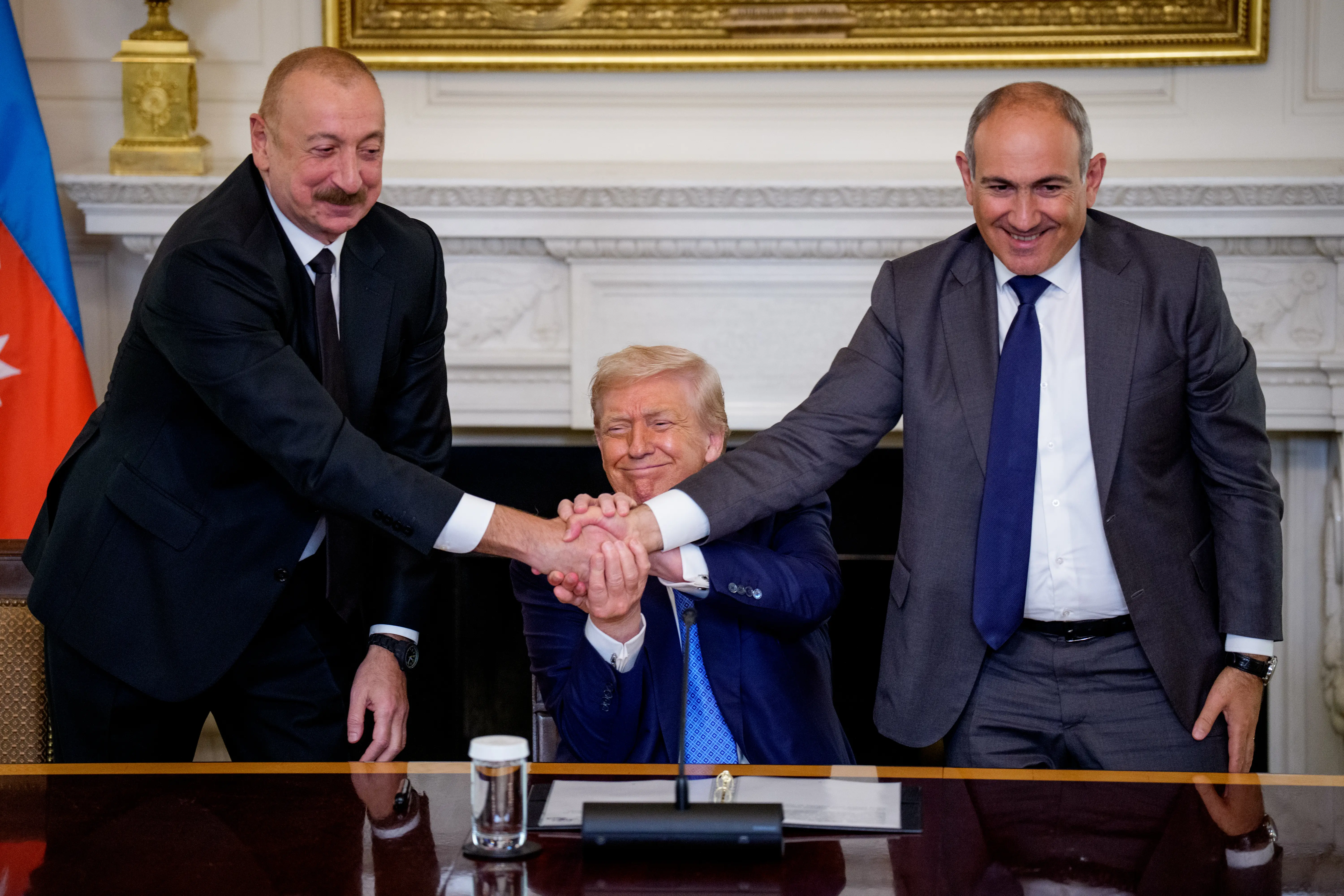 President Donald Trump joined hands with Azerbaijani President Ilham Aliyev (left) and Armenian Prime Minister Nikol Pashinyan (right) during a signing ceremony at the White House.