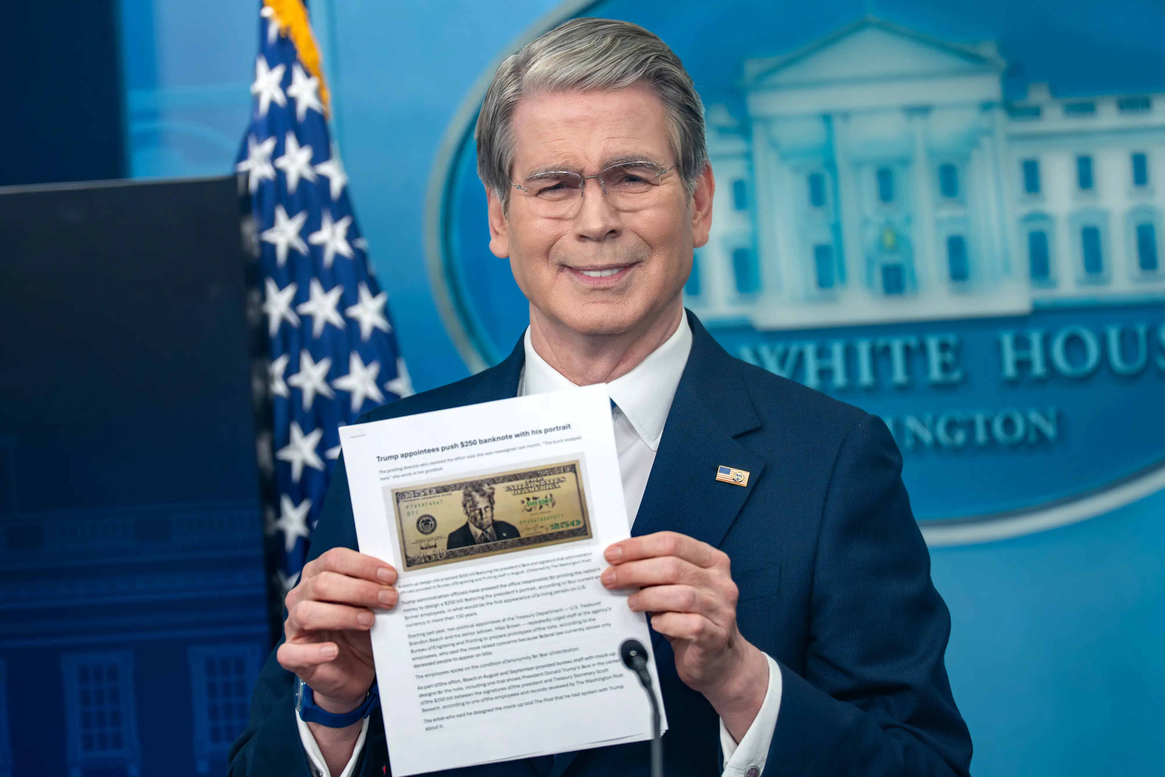Scott Bessent holds a photo of a proposed $250 banknote featuring an image of President Donald Trump.