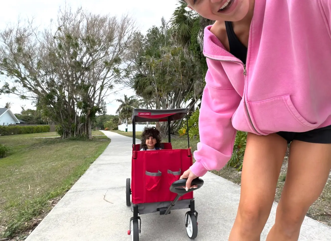 Woman pulling child in a wagon