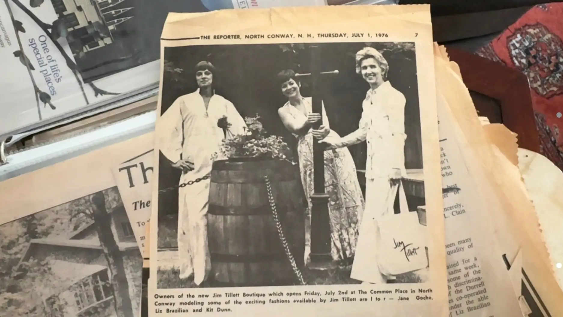 Newspaper clipping with photo of three people near barrel
