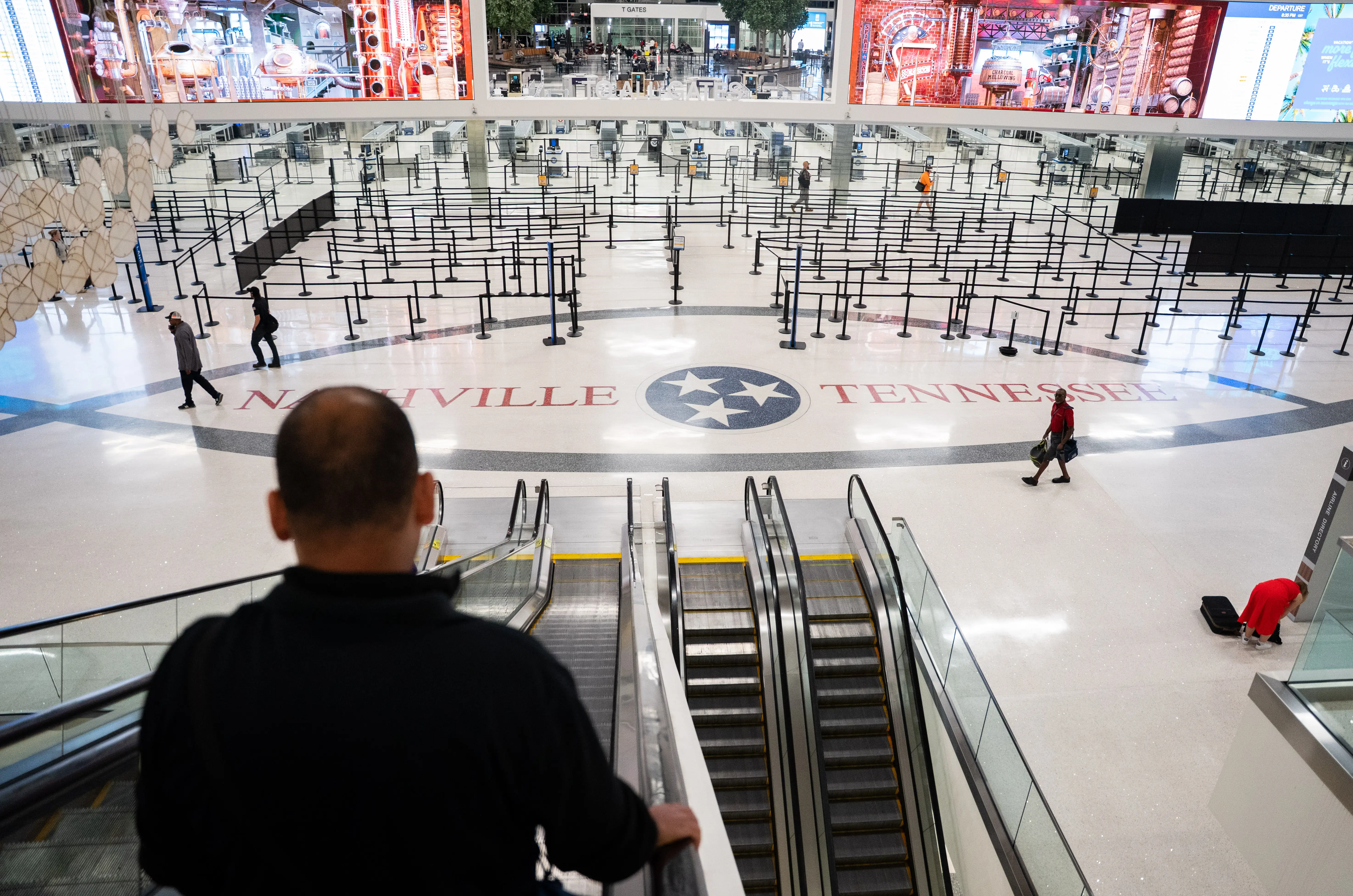 Travelers make their way to the gates during a temporary ground stop at the Nashville International Airport.