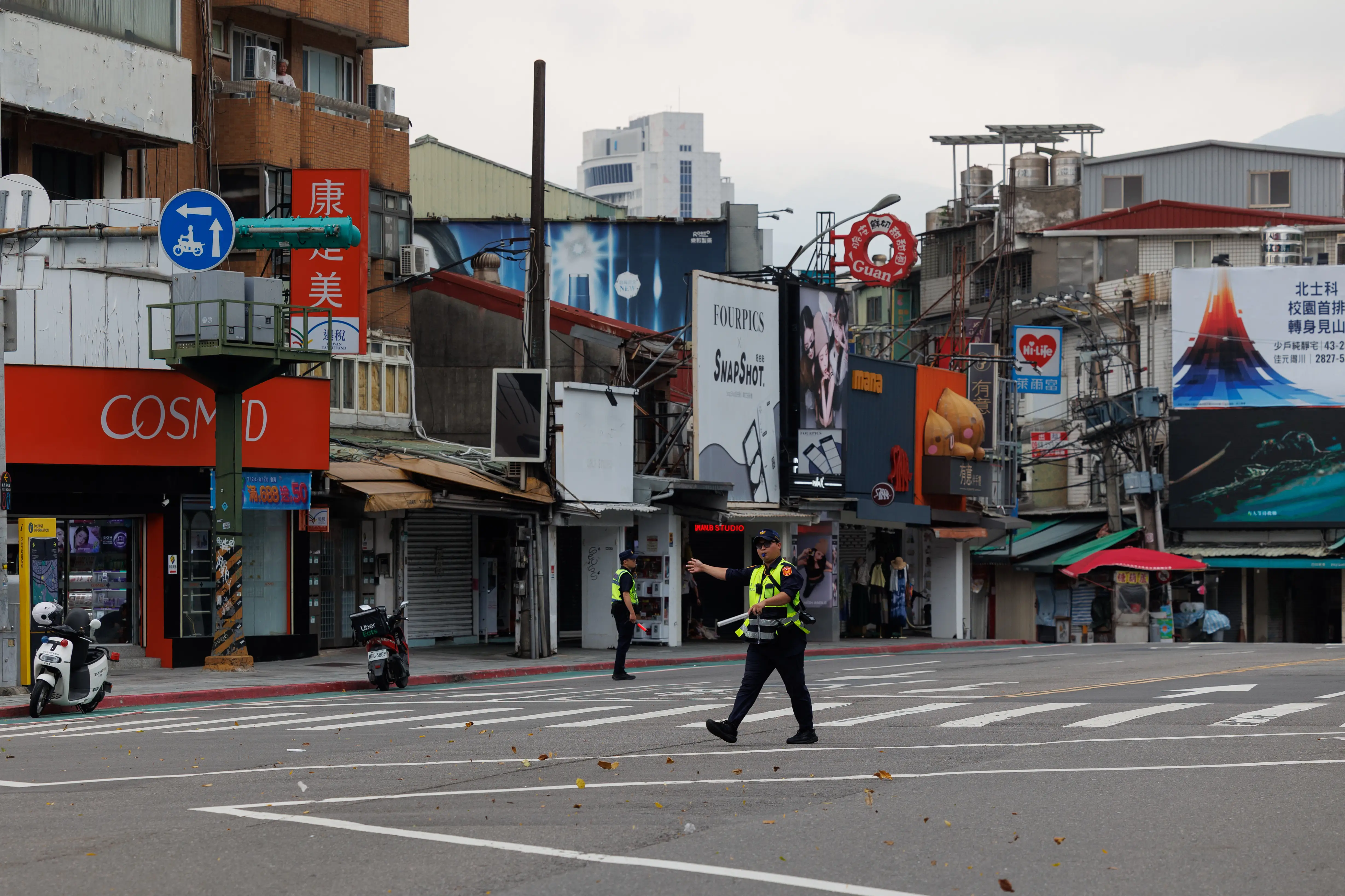 Policemen in central Taipei order people indoors.