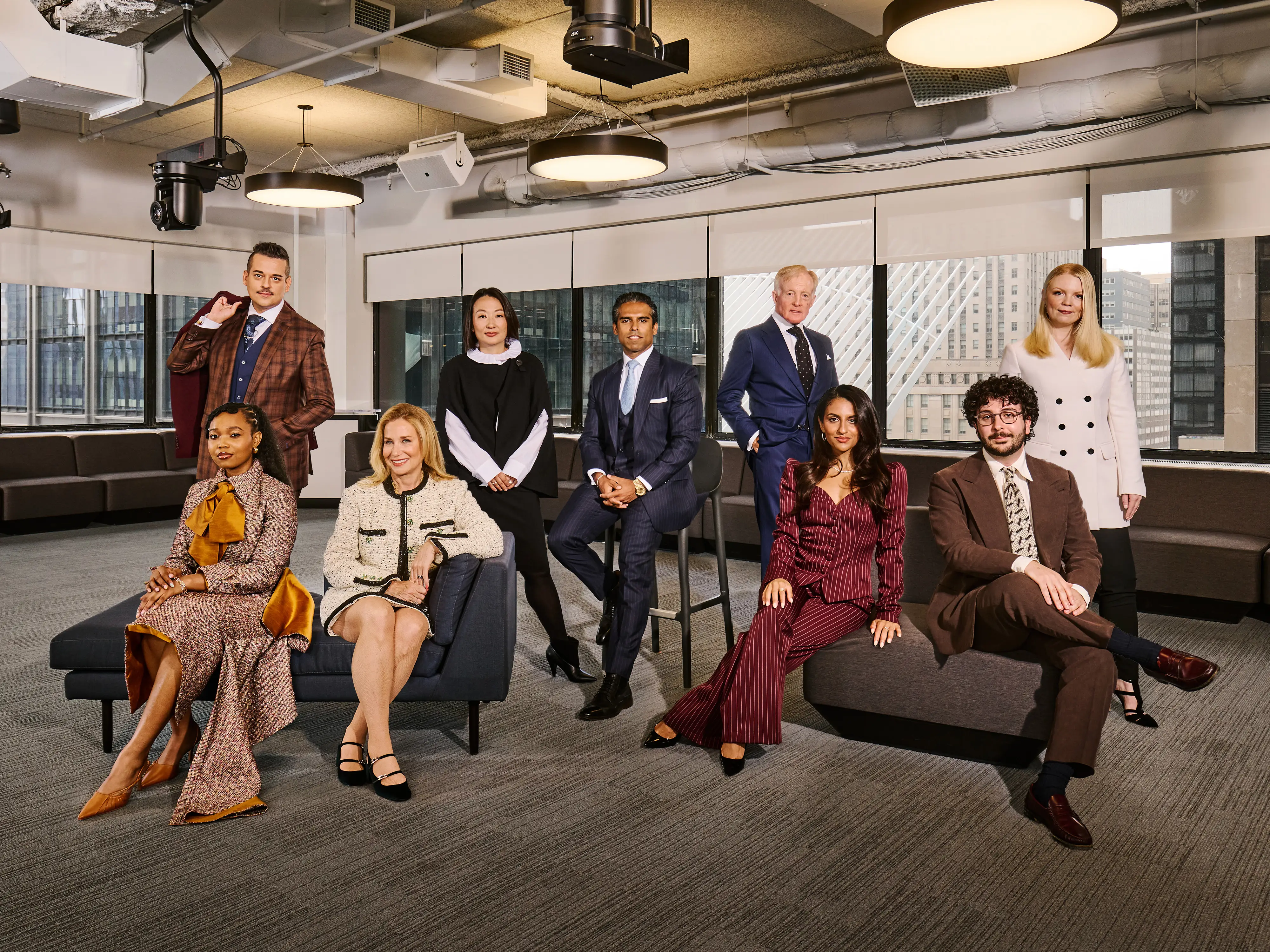 Nine well-dressed lawyers are assembled in a high-rise office building.