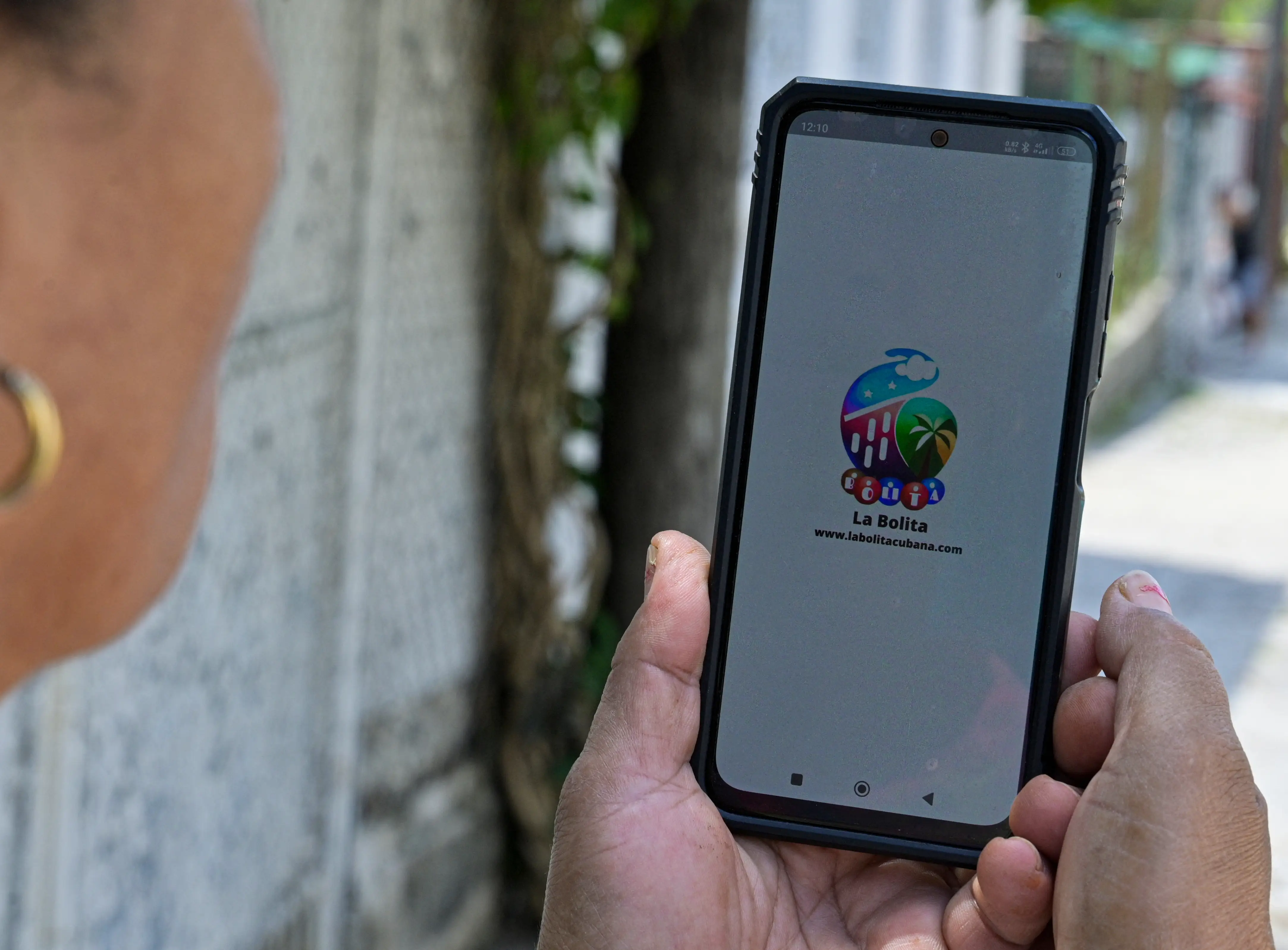 A woman checks on a mobile app the winning numbers of the 