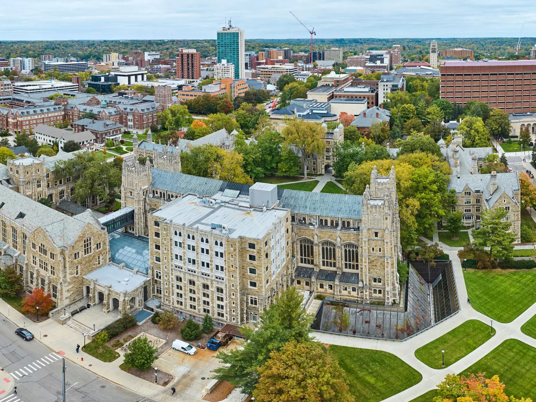 Aerial view of the University of Michigan Law Quadrangle and surrounding Ann Arbor campus buildings in autumn.