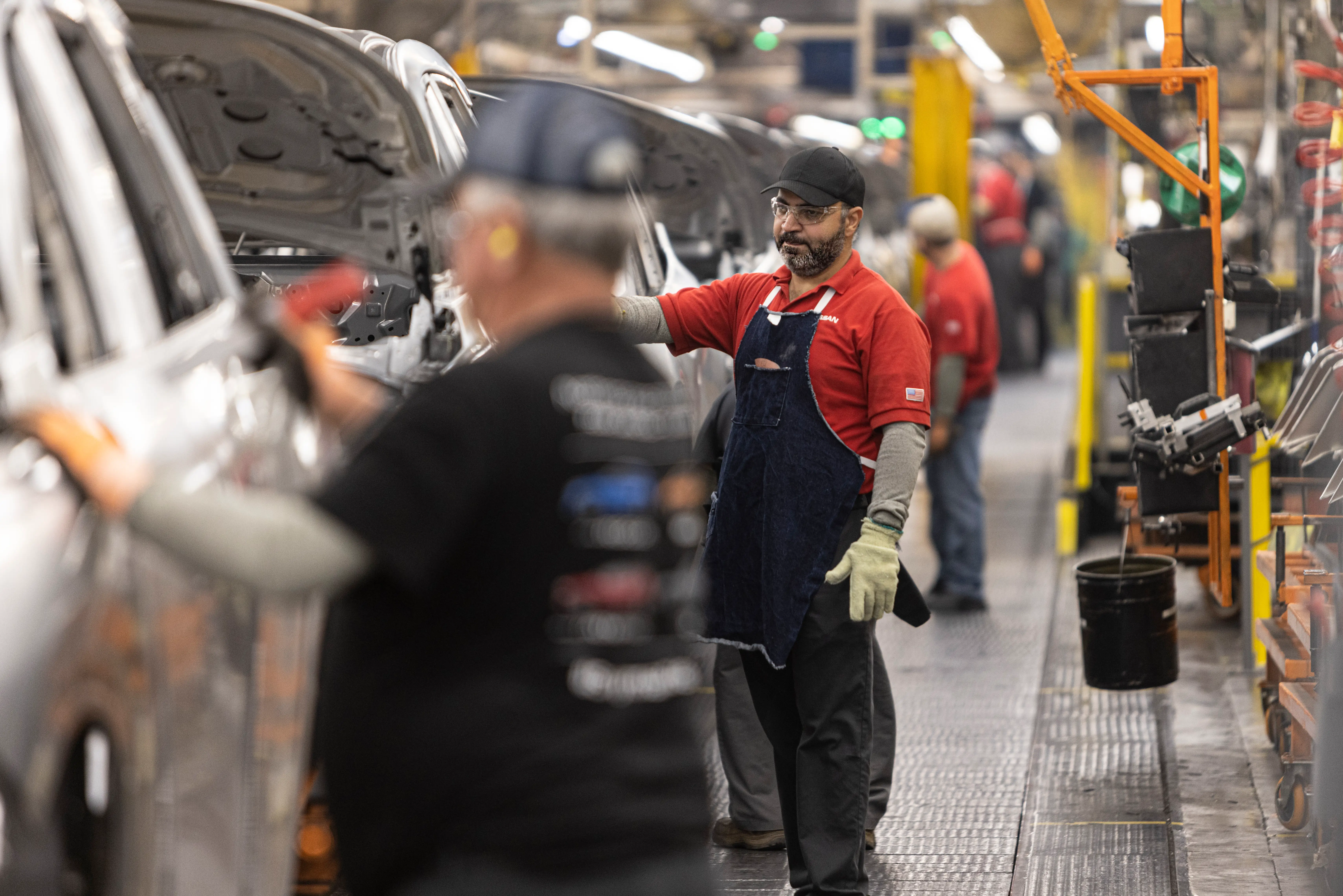 Nissan assembly line employees work on cars in the Smyrna, Tennessee, plant.