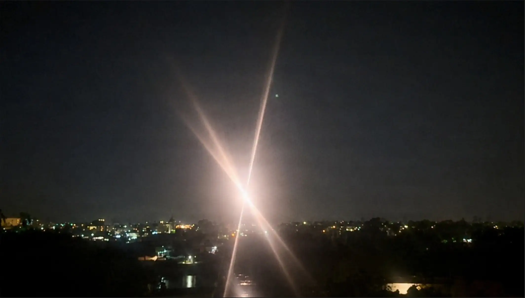 A US laser weapon hits and destroys a drone at night.