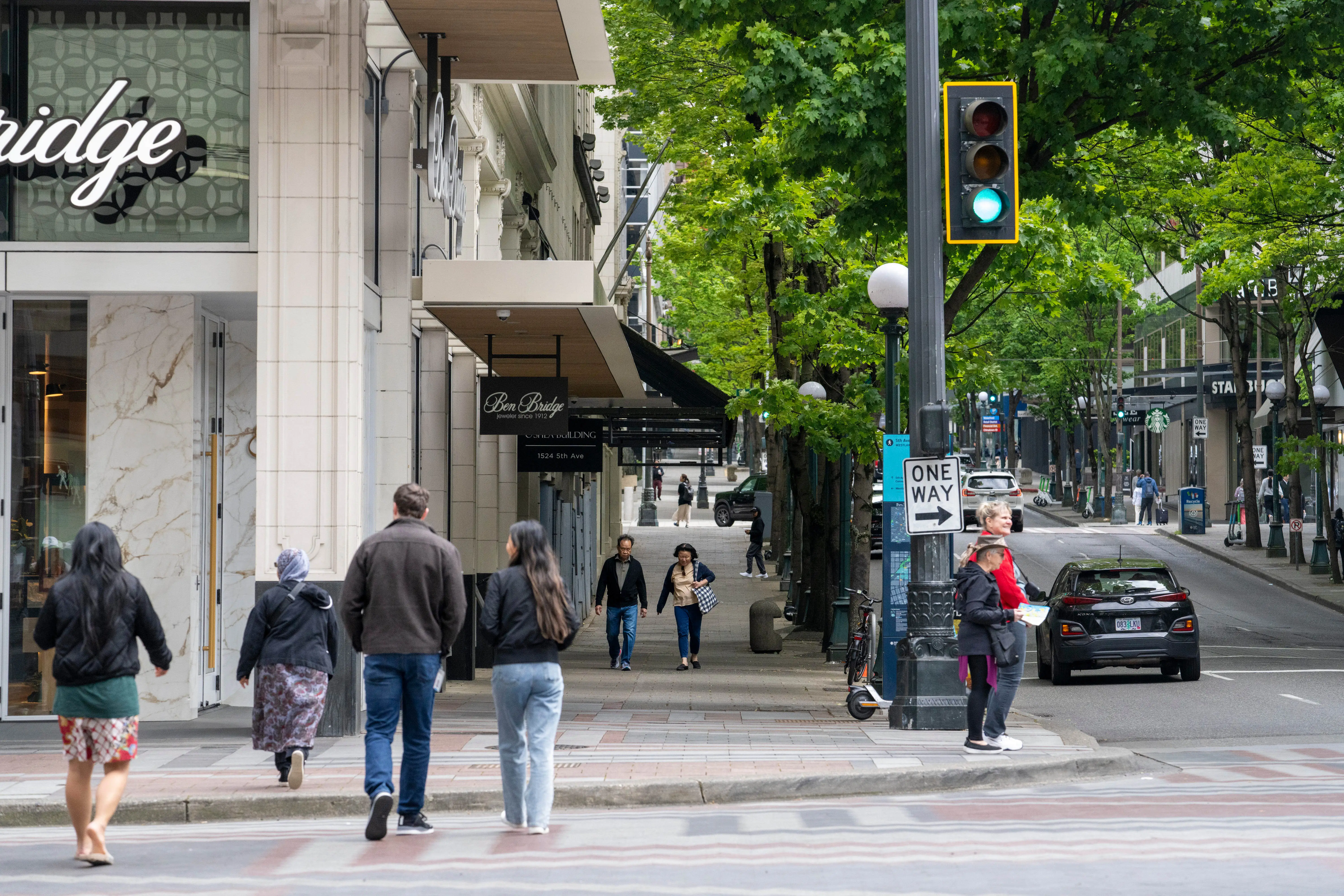 Pedestrians walk in the downtown area of a city.