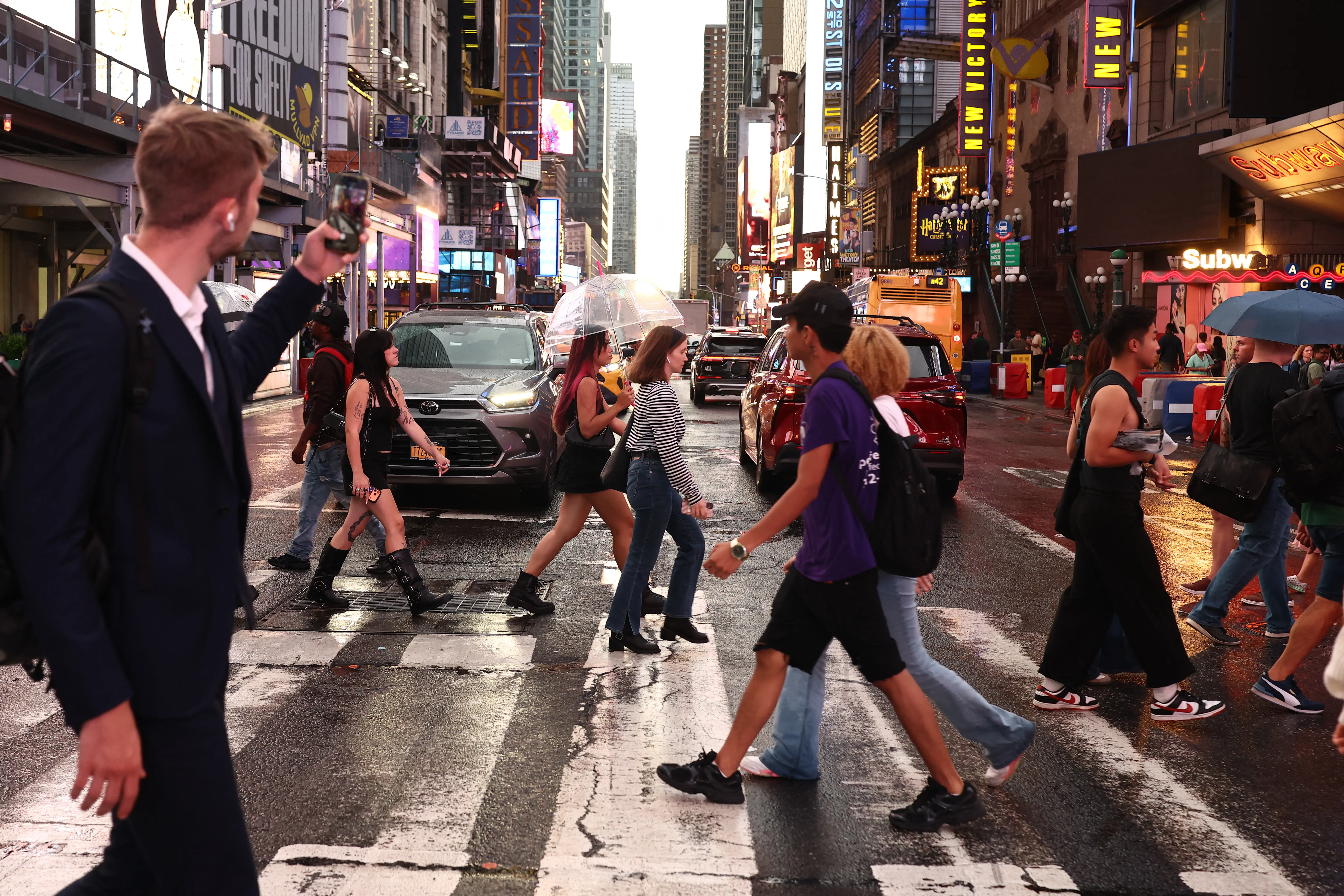 Pedestrians cross the sidewalk in downtown New York City.