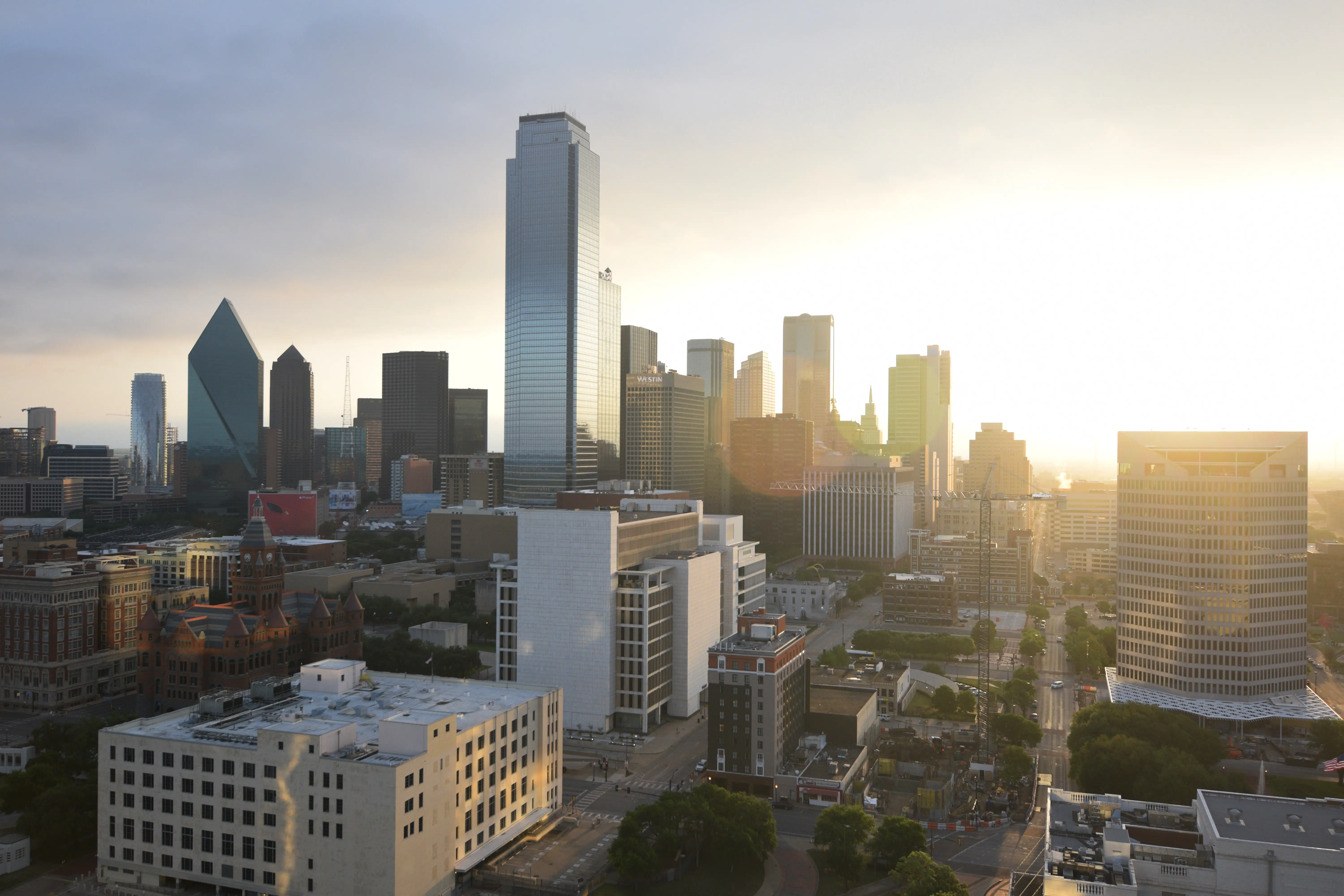 The early morning sunshine shines on a city skyline.