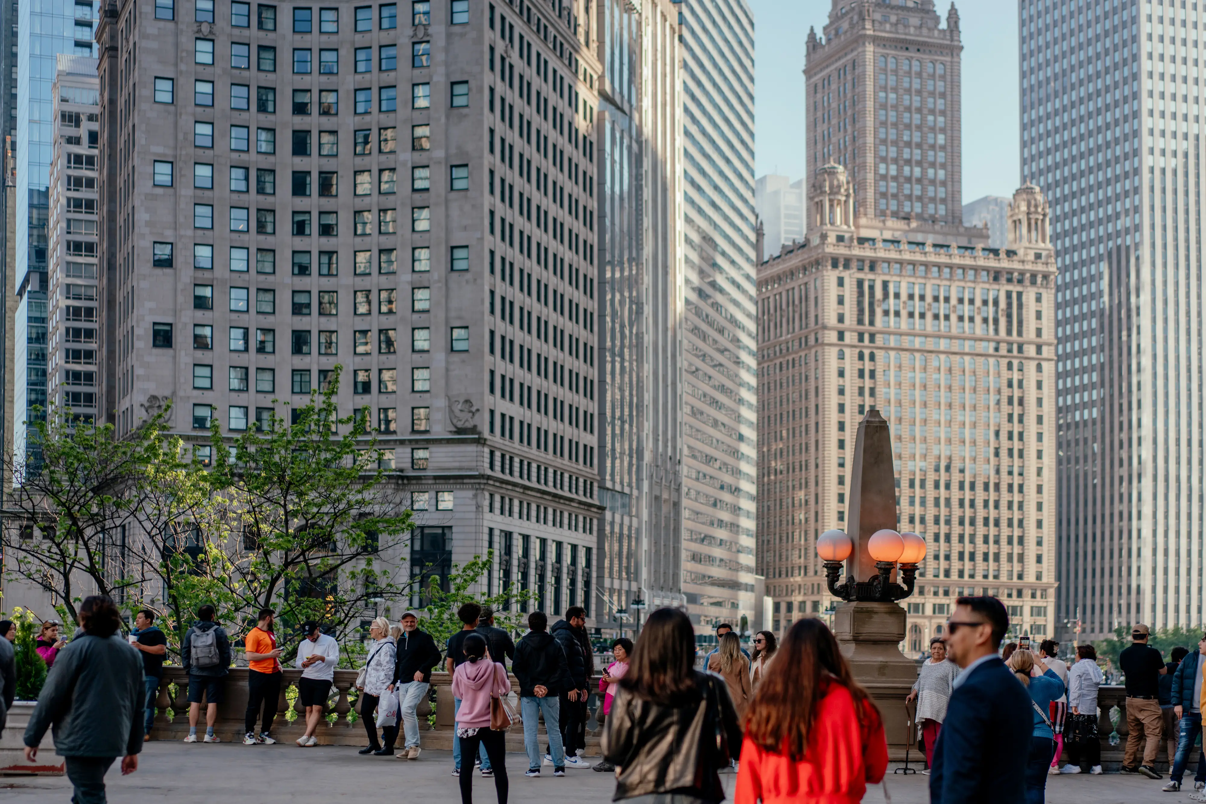 People walk in a downtown area with brick buildings in the background.