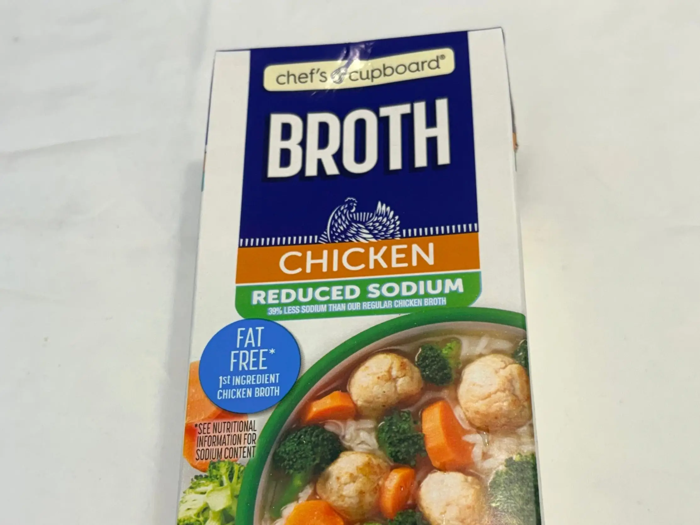 A container of Chef's Cupboard chicken broth from Aldi.