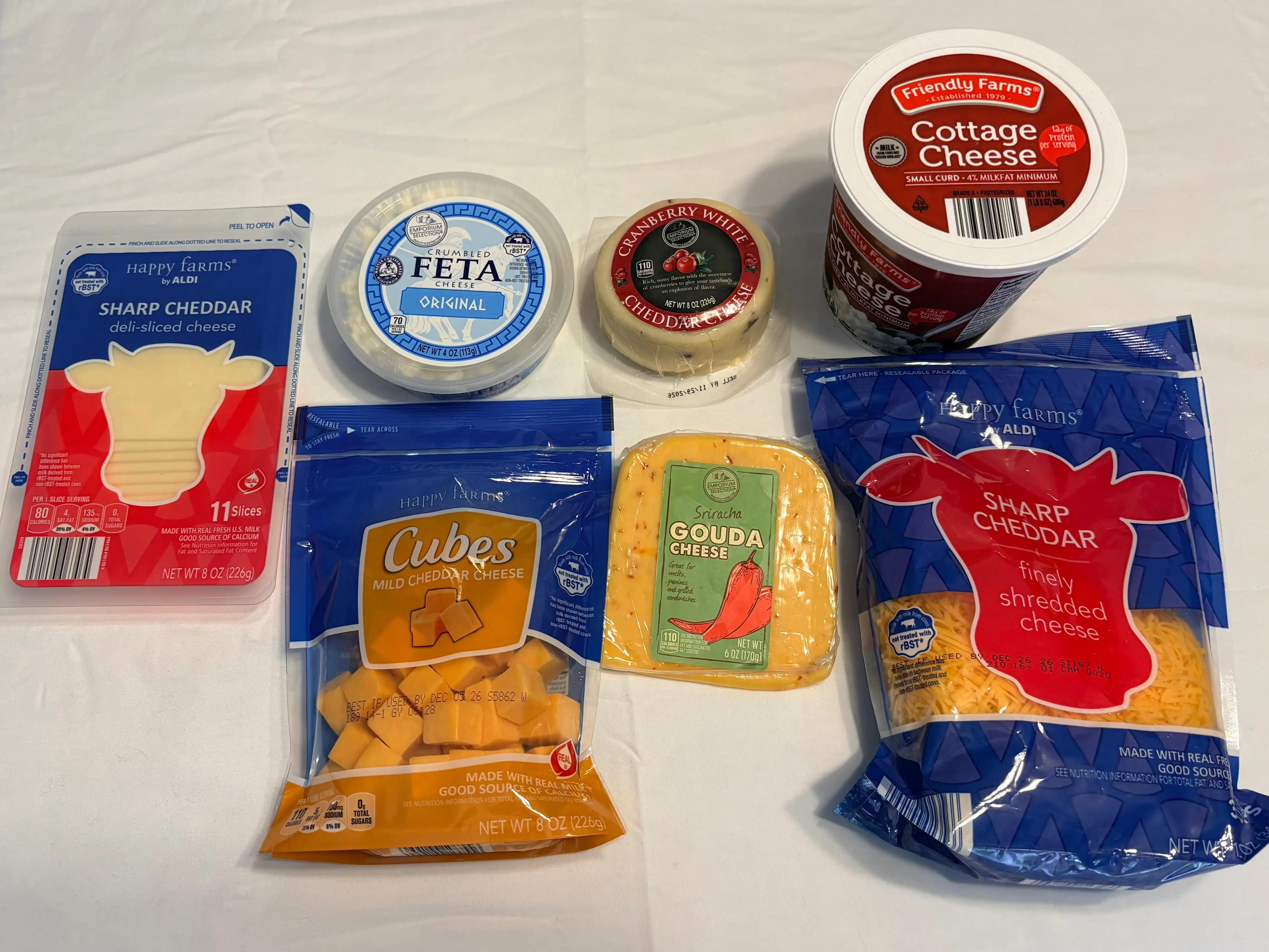 An assortment of cheeses from Aldi is sitting on a table.