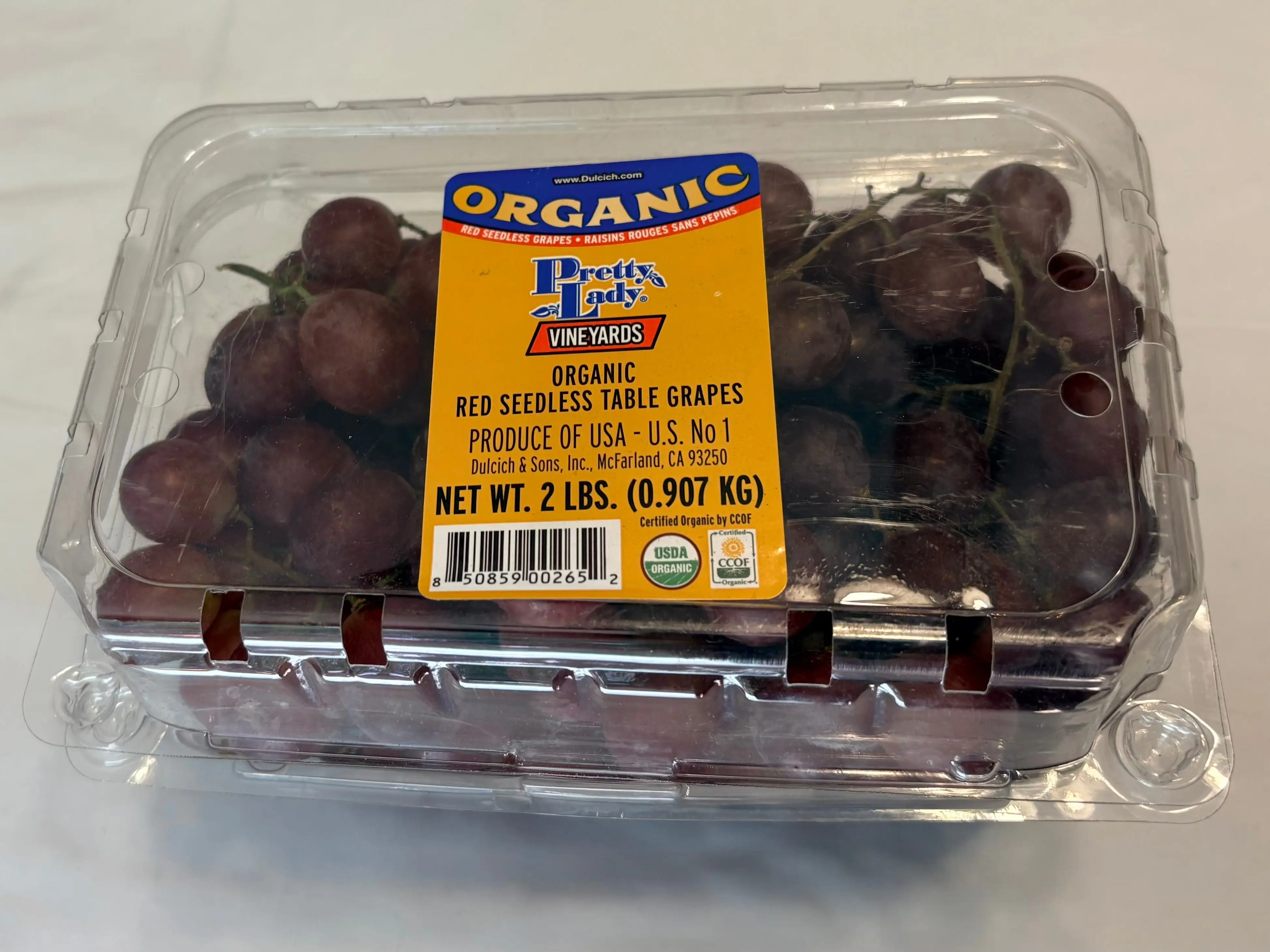 A container of Pretty Lady vineyards red seedless table grapes.