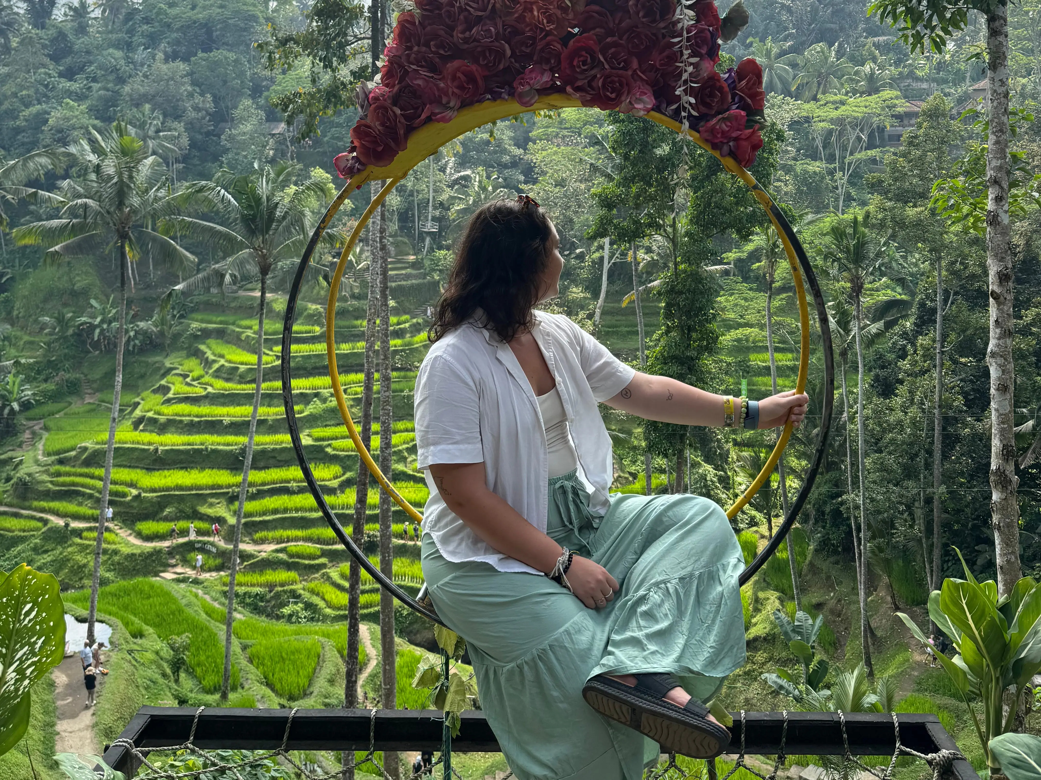 A woman standing by rice fields in Bali, Indonesia.