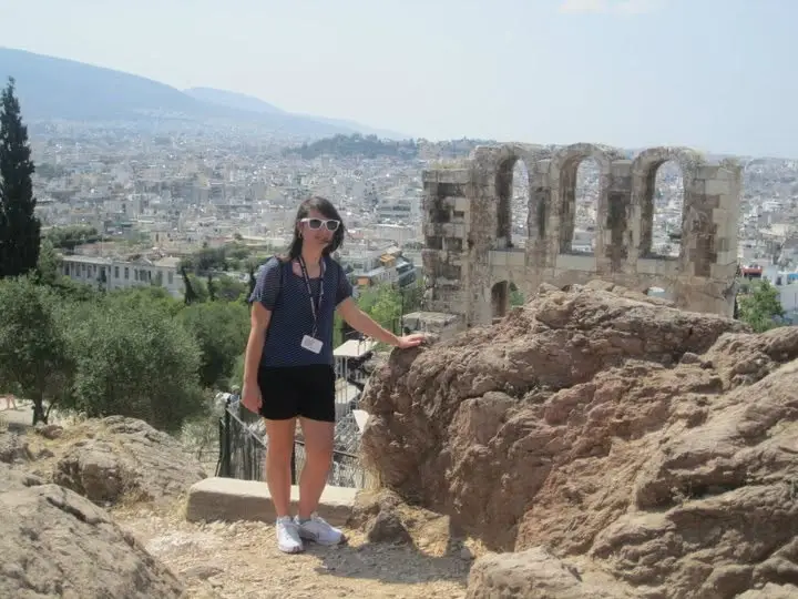 A woman wearing sunglasses and traveling in Europe.