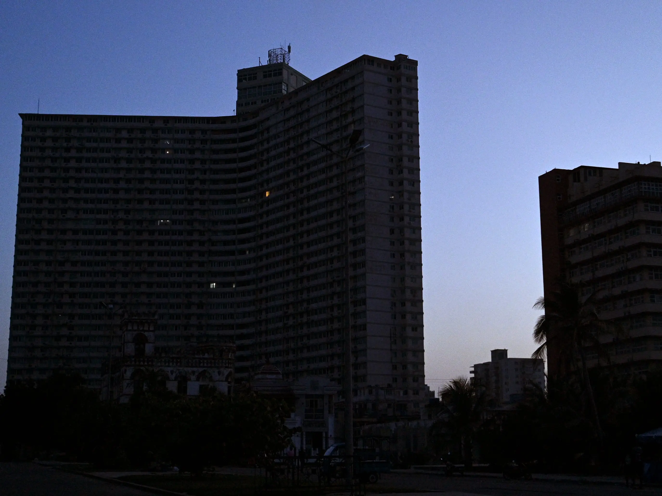 Buildings stand in darkness during a nationwide blackout in Havna, on July 14, 2026. Cuba's power grid failed for the third time in less than 10 days, sparking another nationwide blackout, the national electricity company said.