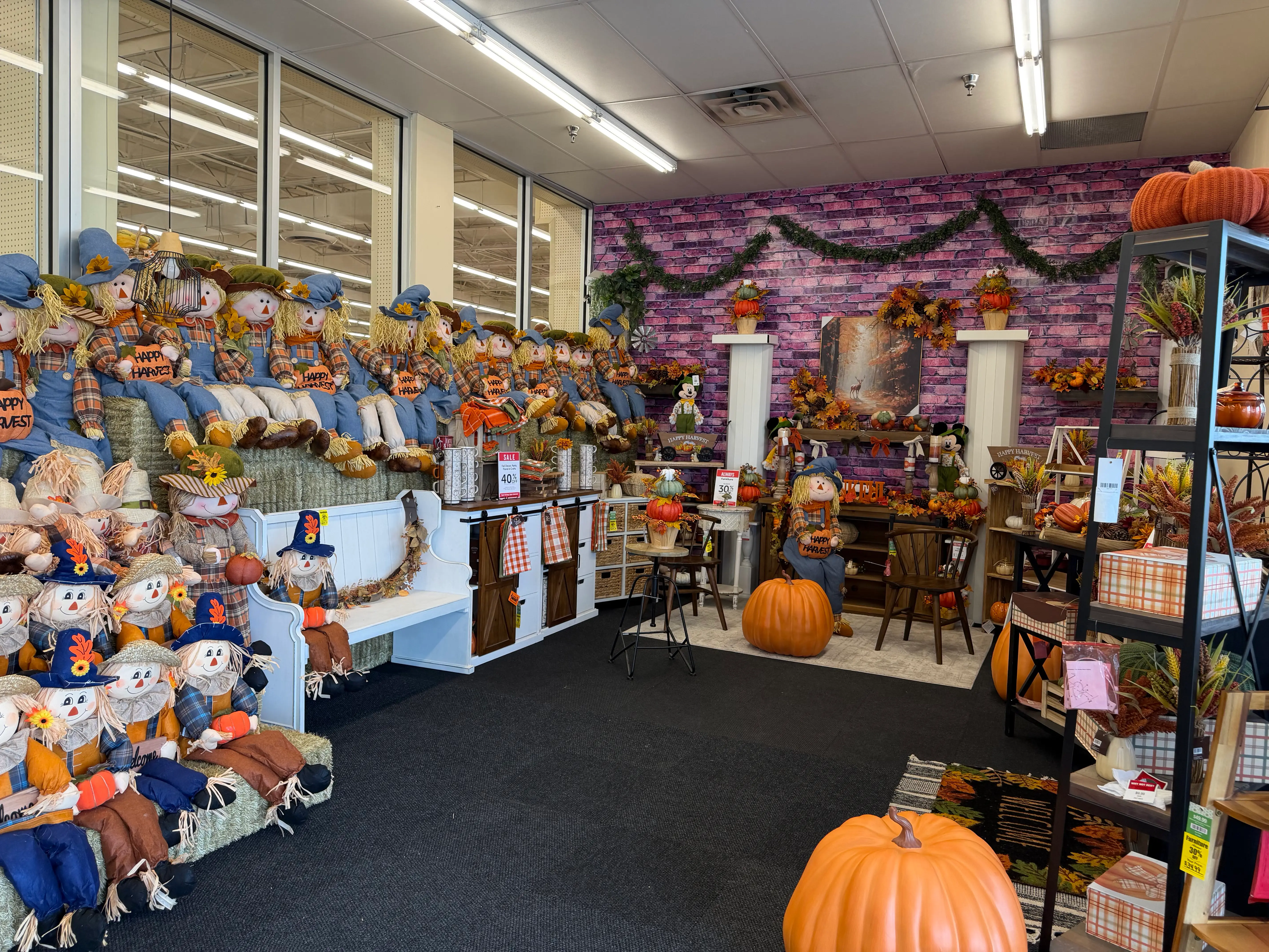 Fall decor display with scarecrows, garland, at Hobby Lobby