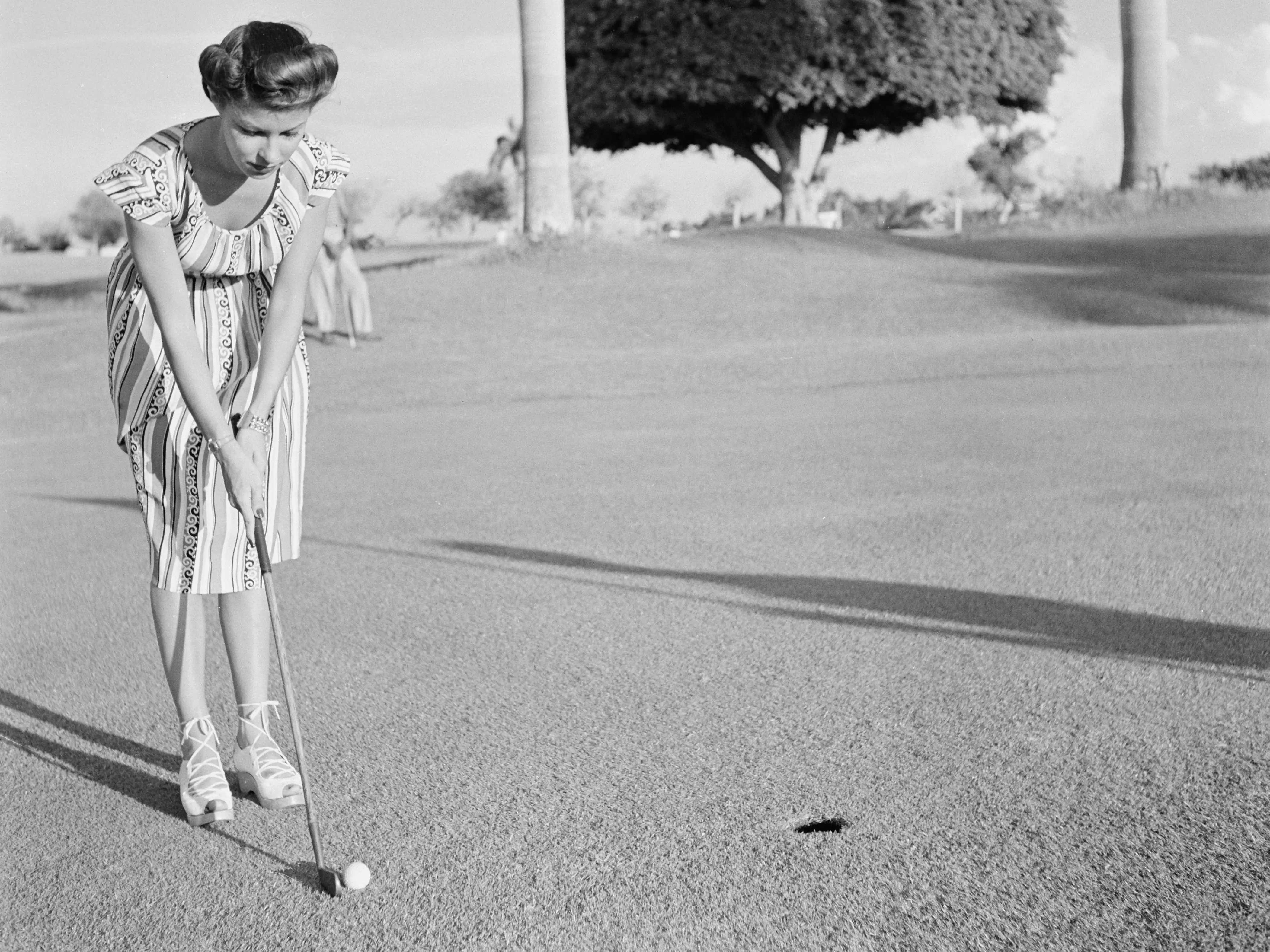 HAVANA, CUBA - MAY 1946: A woman putts during a golf game in Havana, Cuba.