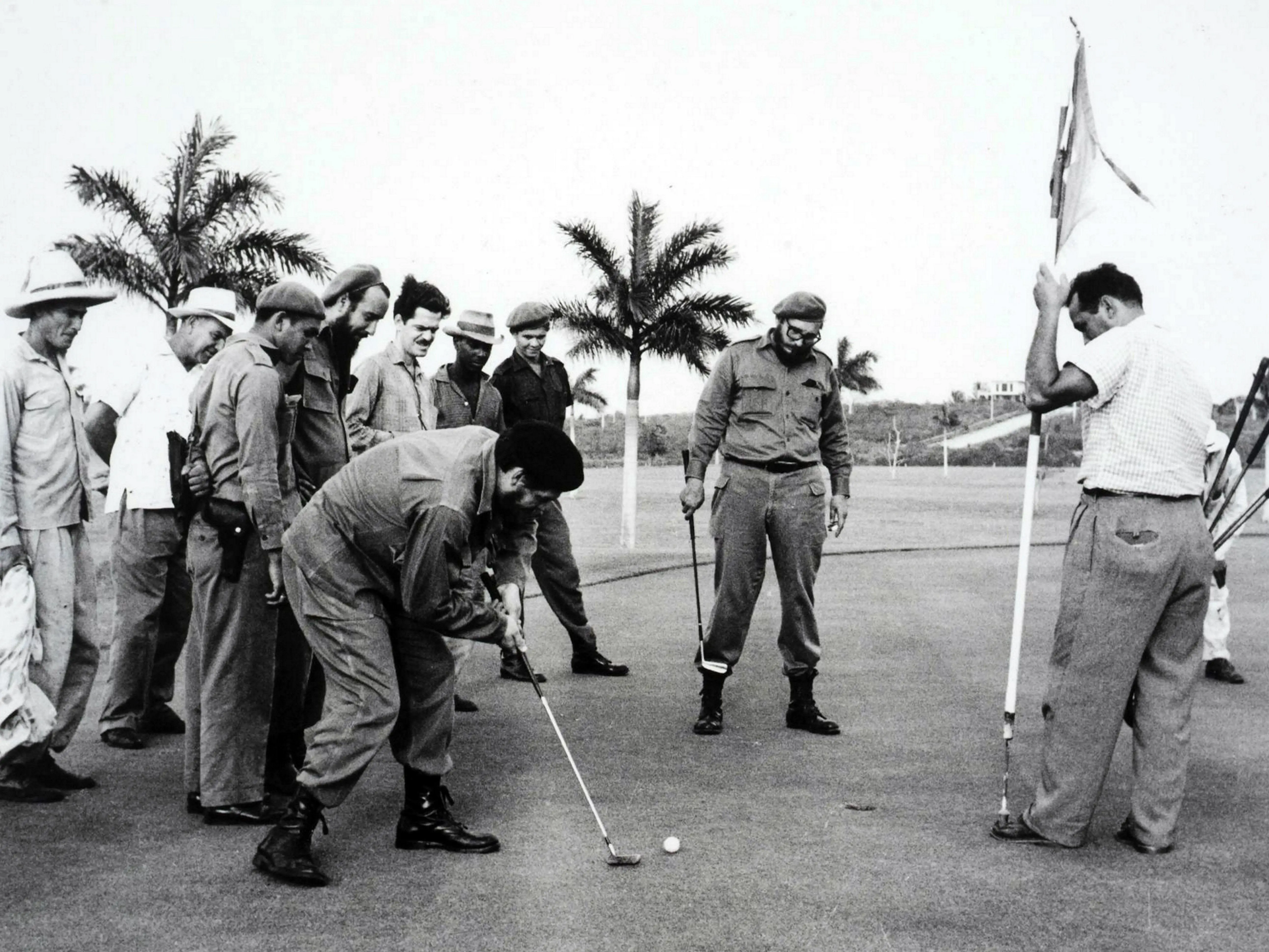 HAVANA, CUBA - 1962: Che Guevara (1928-1967) putts as Fidel Castro (1926-2016) watches, during 1962 golf game at Havana's Colinas de Villarreal golf course, following the Cuban missile crisis.
