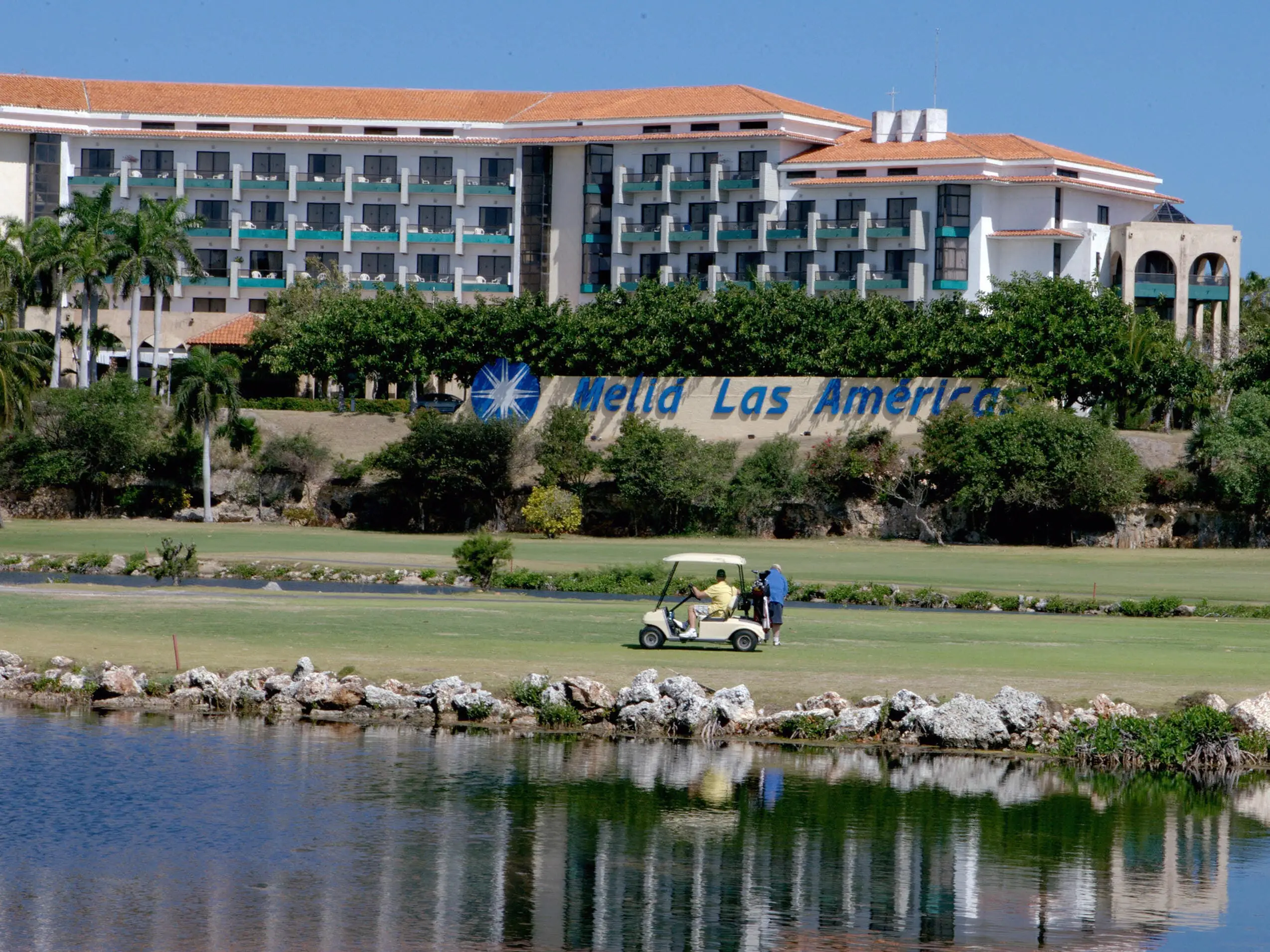 Tourists play golf in front of a hotel in Varadero beach, 130 km east of Havana on April 6, 2008. The lifting, by Cuban President Raul Castro, of the prohibition to Cubans of staying at tourism hotels, created expectations on their arrival to Varadero. Still, only few Cubans visit nowadays Varadero because of the high prices.