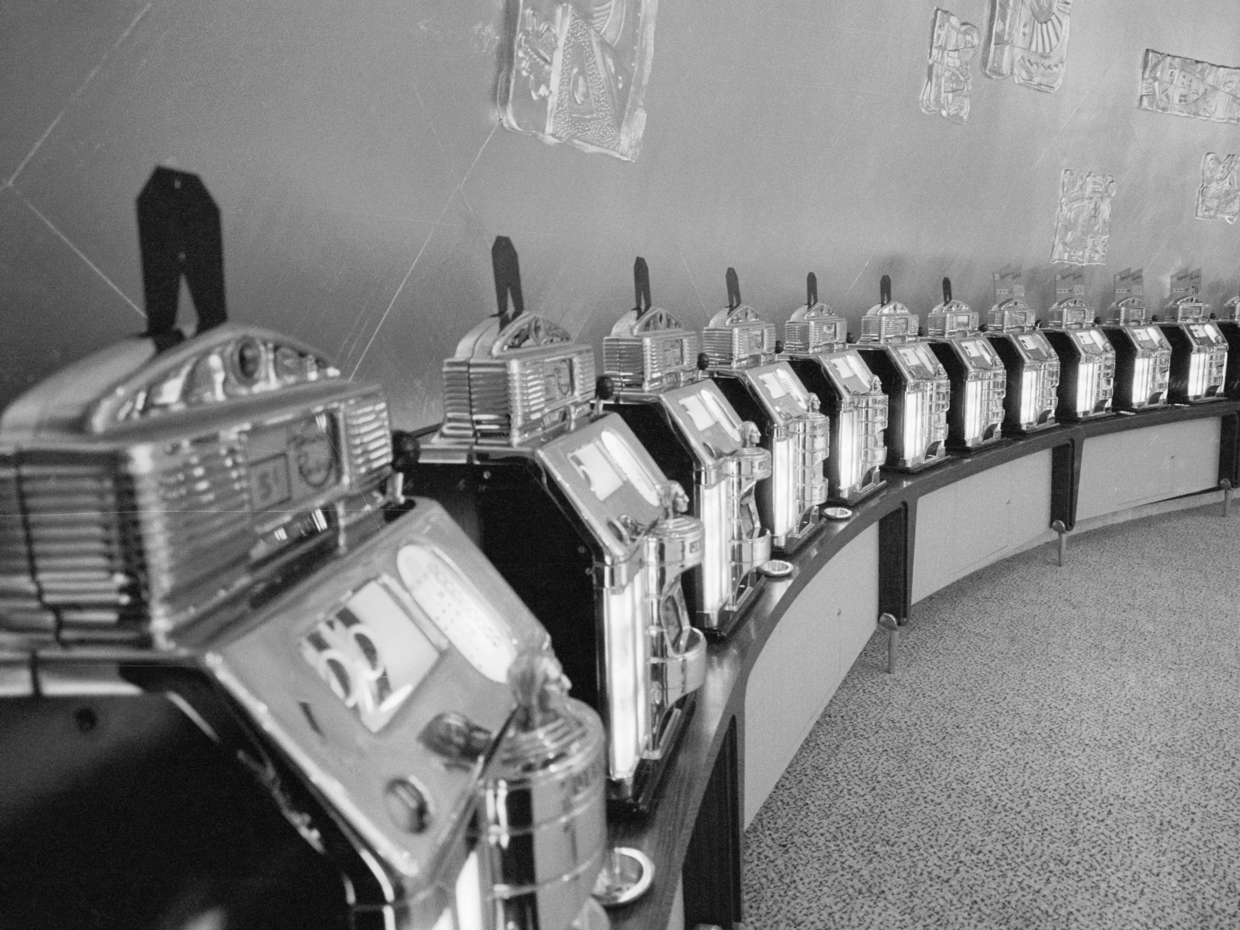 Tourist Attractions. Havana, Cuba: Even the slot machines in the casino seem to have a modern look. The walls of the casino are embellished in gold leaf with large-scale designs reminiscent of Mayan jewelry. 1958