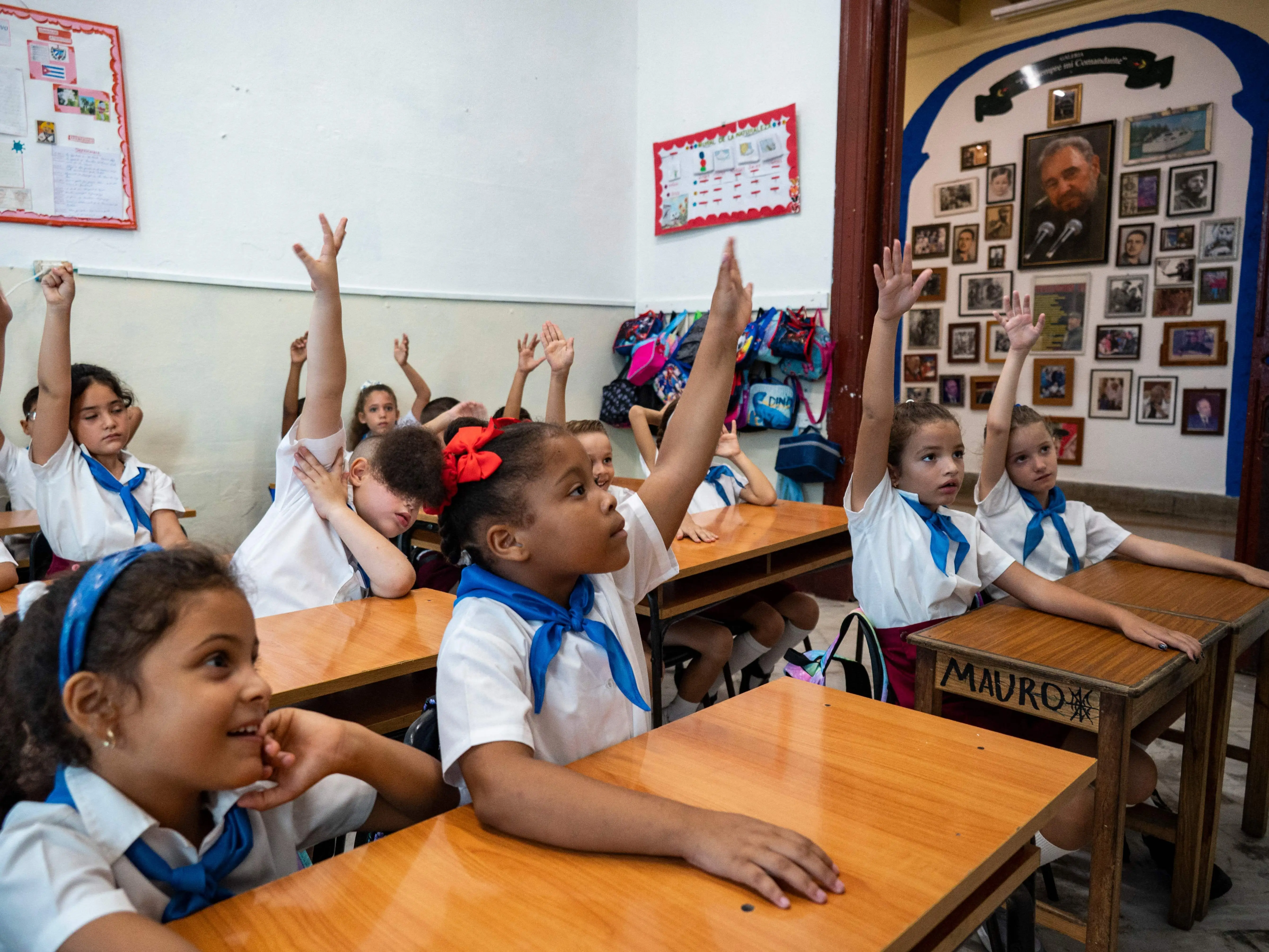 Children raise hands in their classroom on their first day of school in Havana on September 4, 2023.